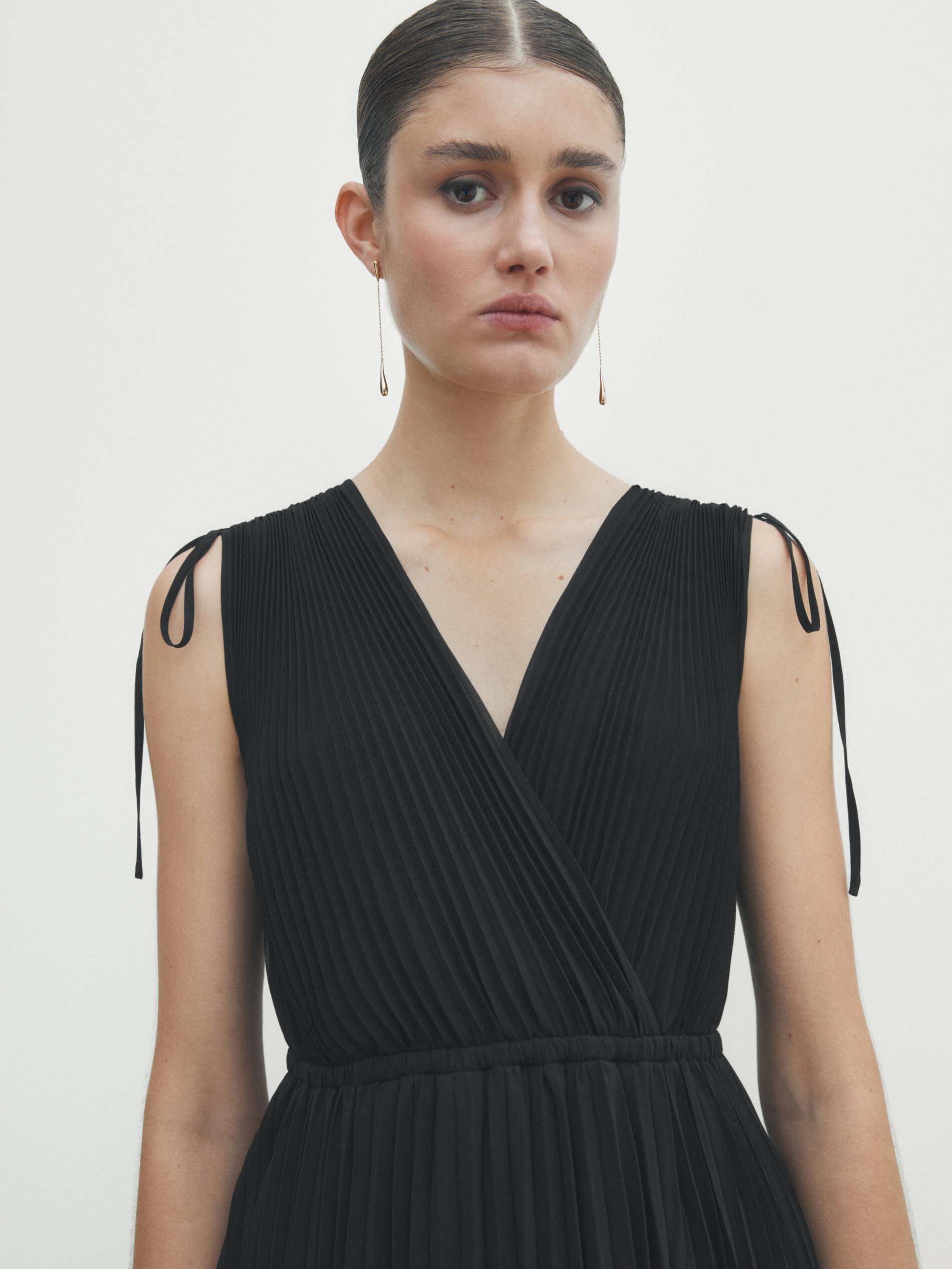 Pleated black dress with drawstrings