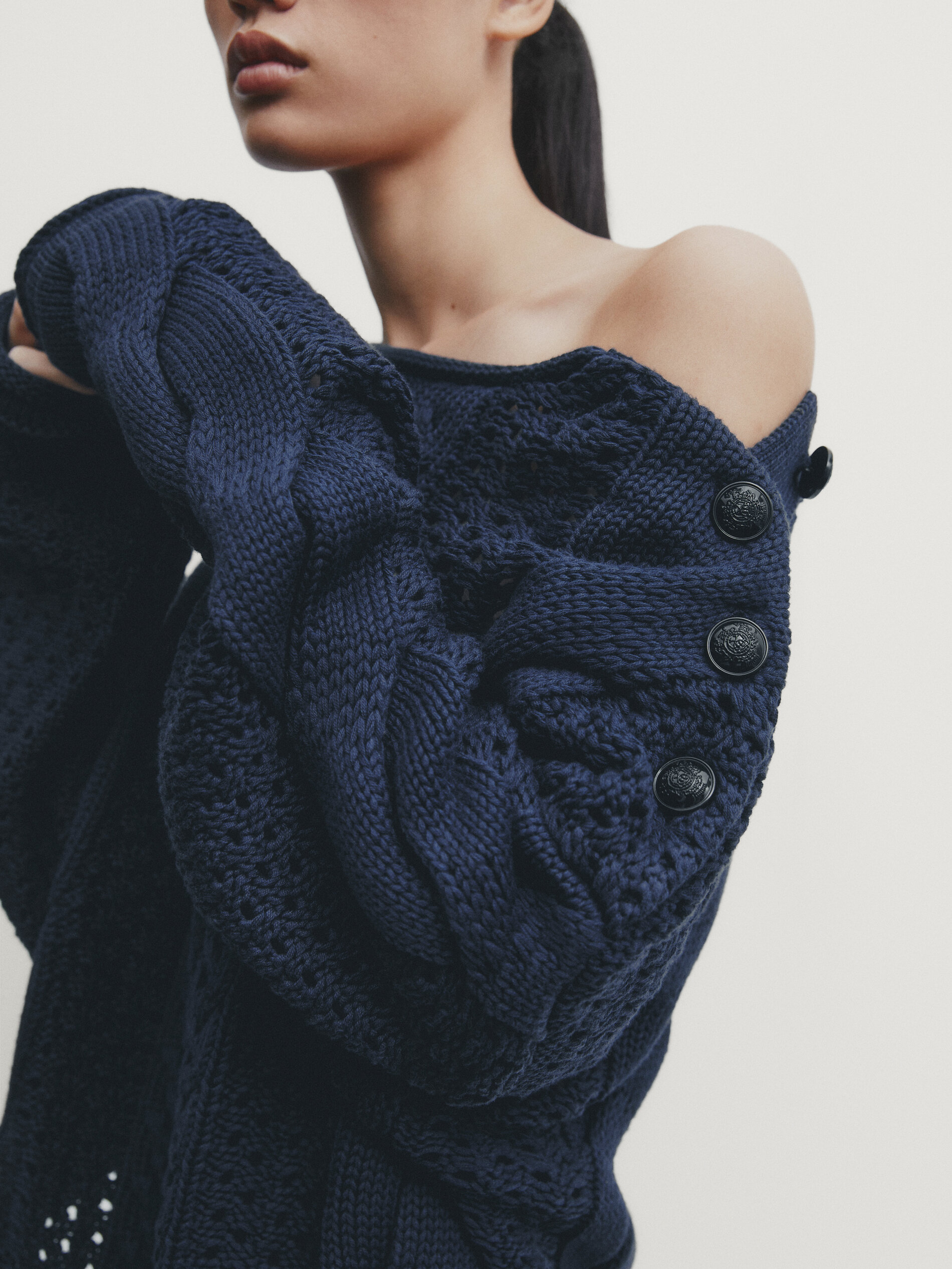 Open knit sweater with button detail