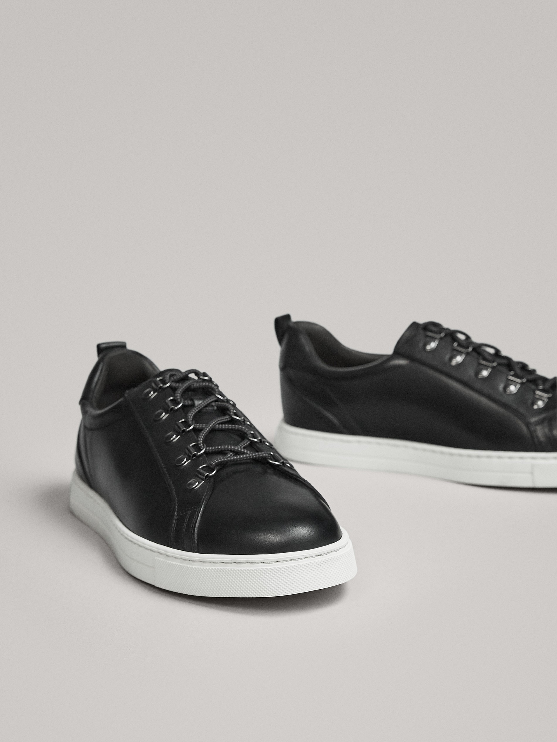 black leather plimsolls