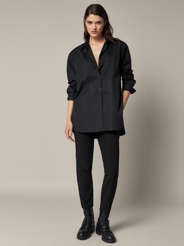 Trousers with front buckle