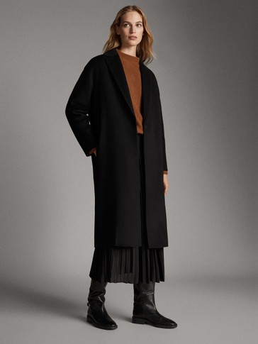 Hand-tailored black quilted wool coat