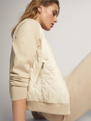 Puffer jacket with contrast knit sleeves