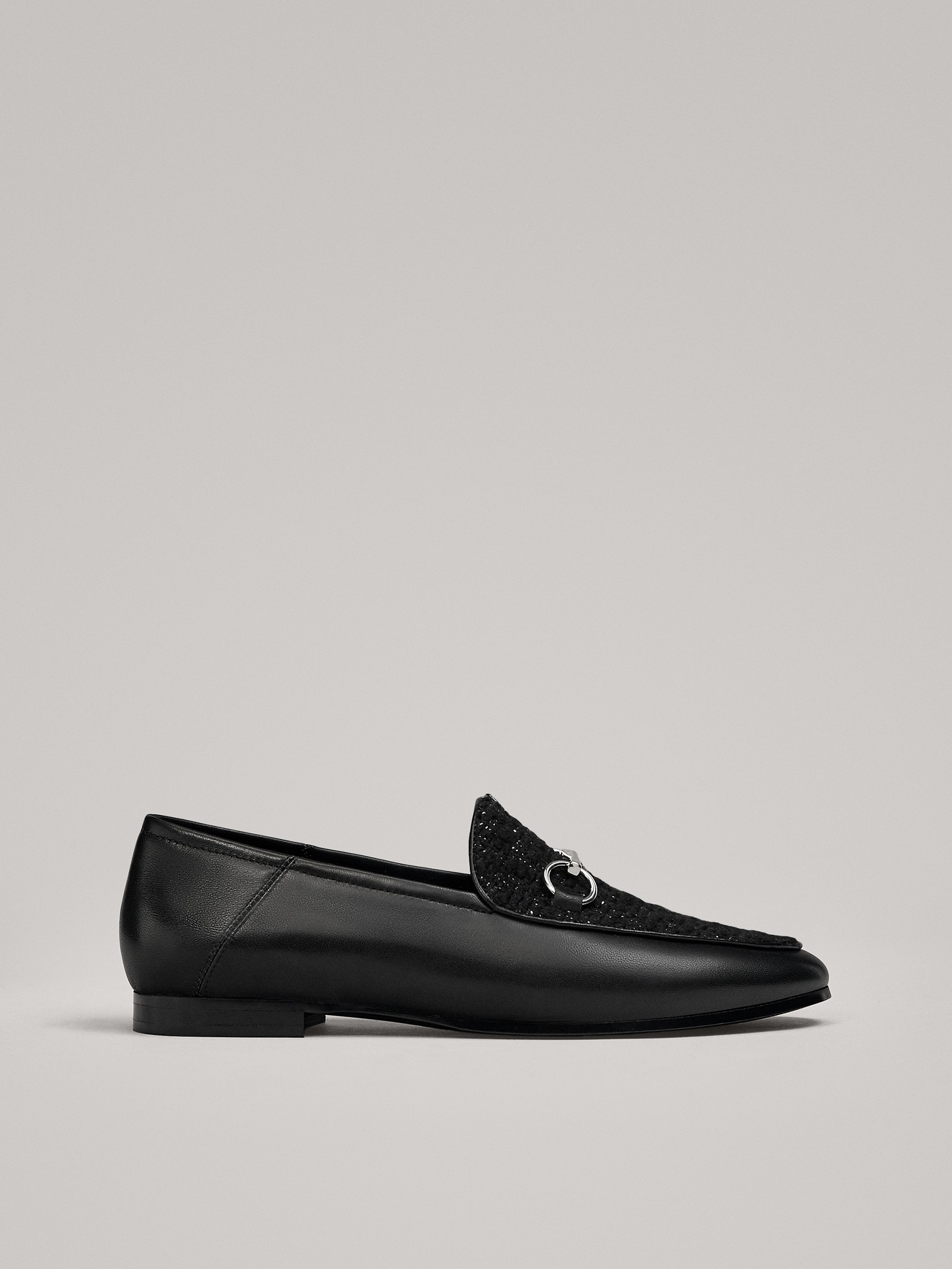 black loafers with silver buckle