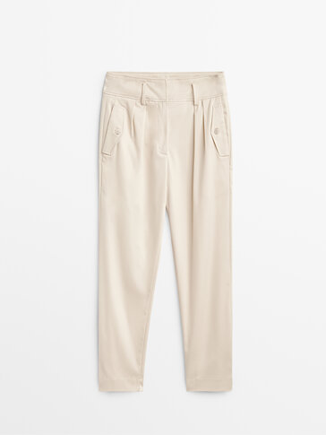 Darted trousers with buttoned pockets