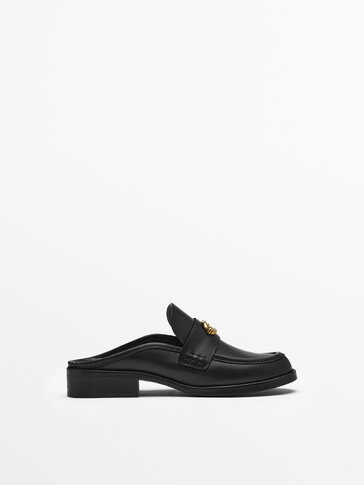 LEATHER MULE LOAFERS WITH METAL APPLIQUÉ