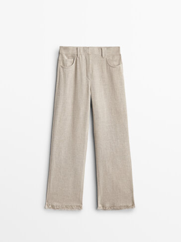 Trousers with frayed hem