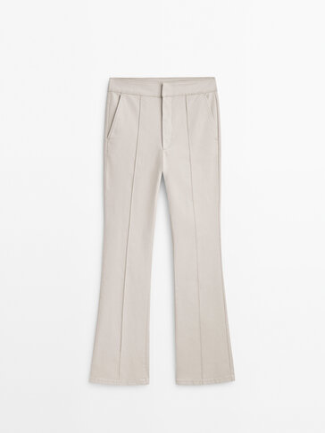 Waxed kick flare trousers with central seam