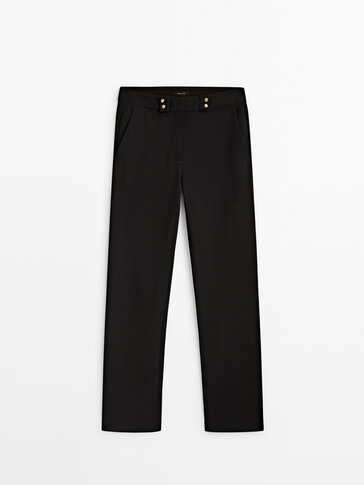 Stretch trousers with golden buttons