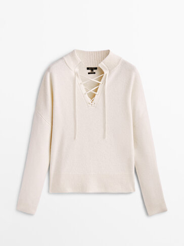 Mock turtleneck sweater with criss-cross straps