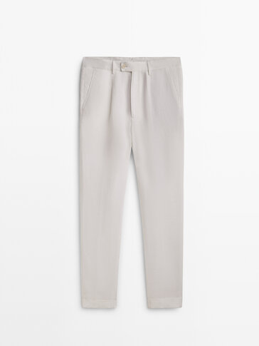 Lniane spodnie o kroju relax fit z zakładkami − Limited Edition