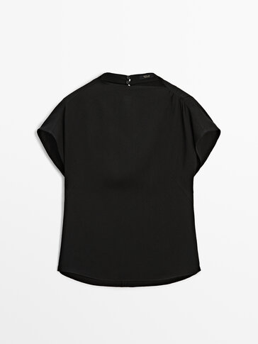 Black short sleeve top with fitted waist