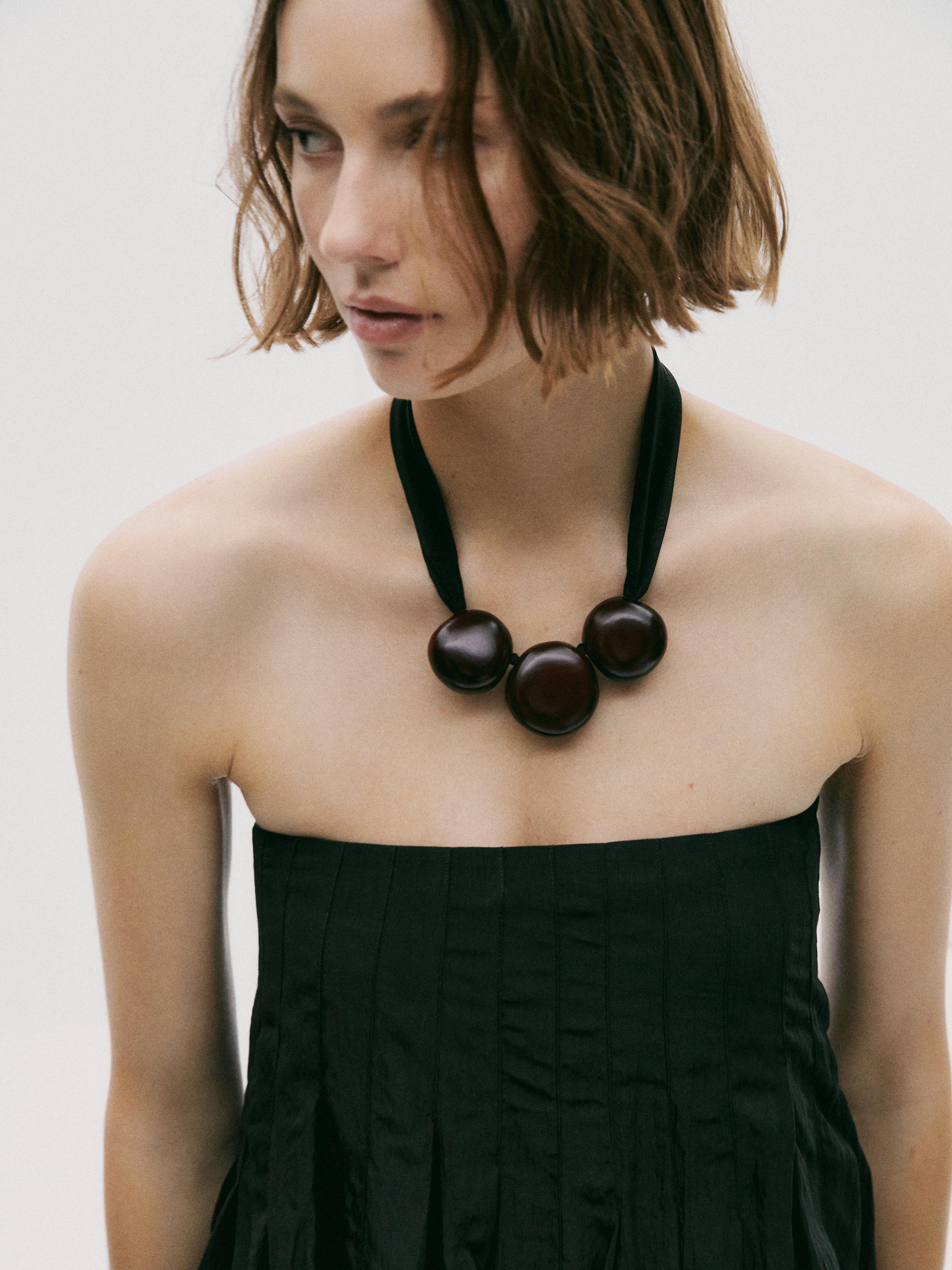 Fabric pendant with wooden beads