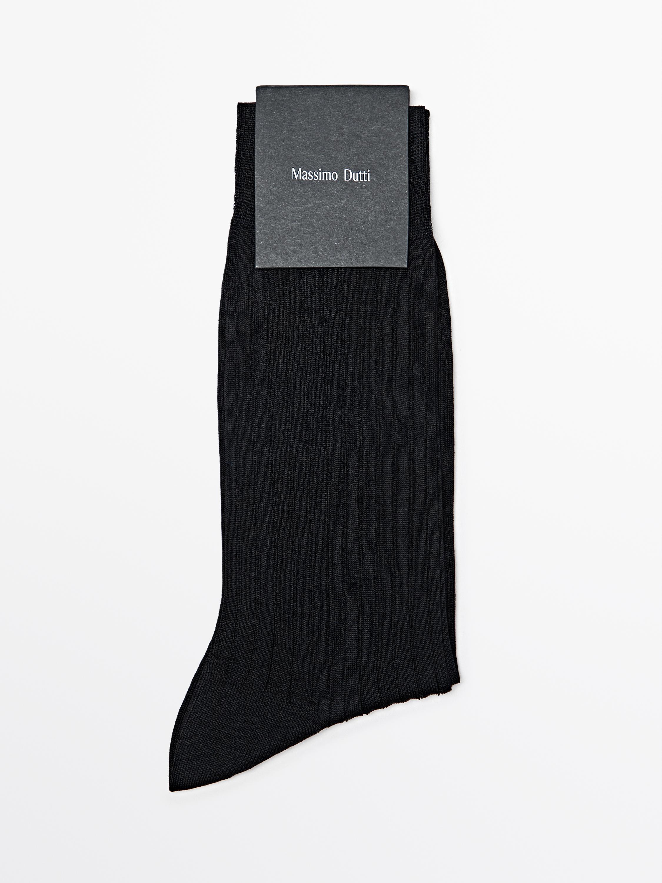 Front view of black dress socks with a ribbed design and "Massimo Dutti" text on the label.
