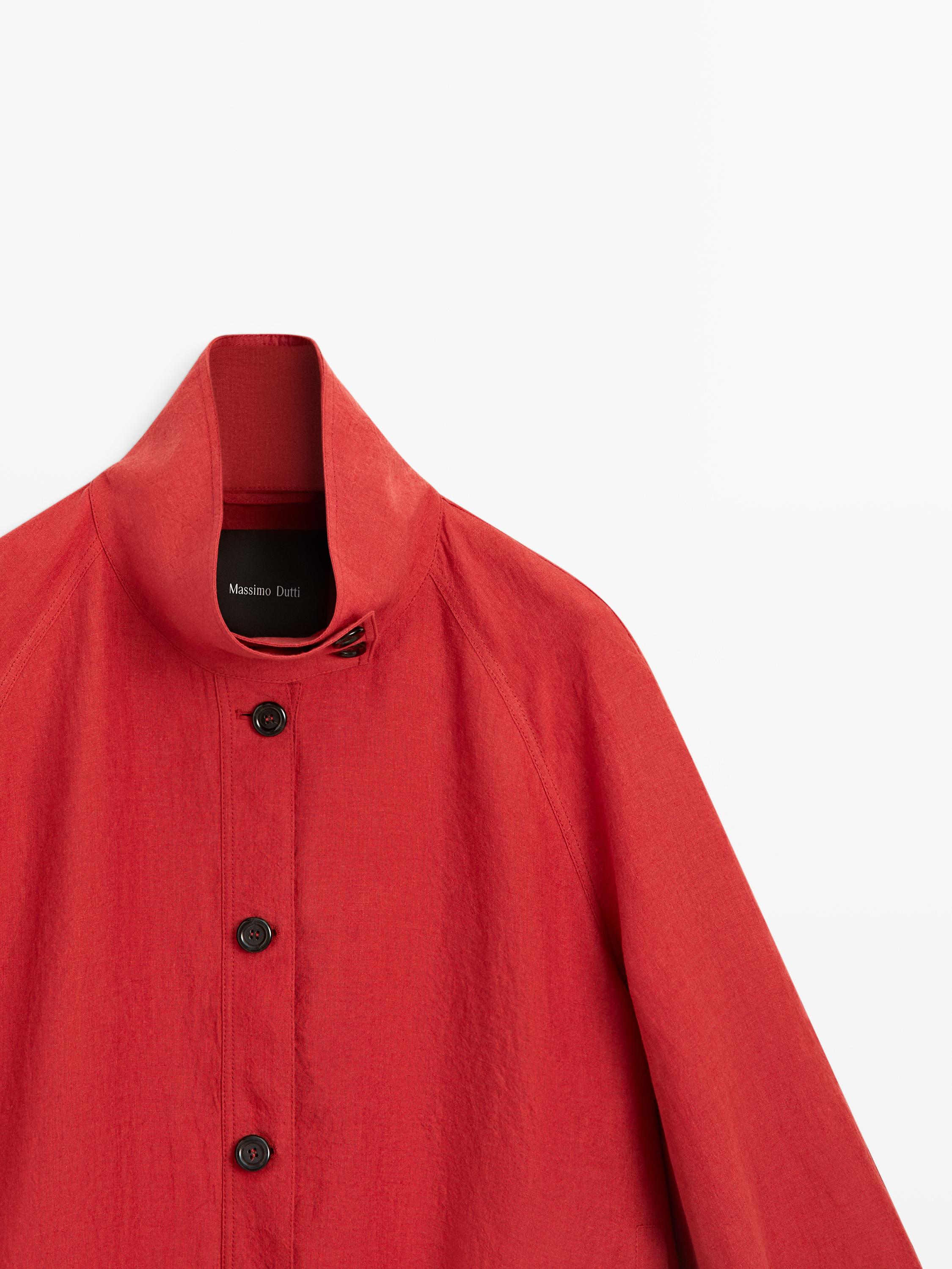 Medium shot of orange bomber jacket with stand-up collar and visible black placket.