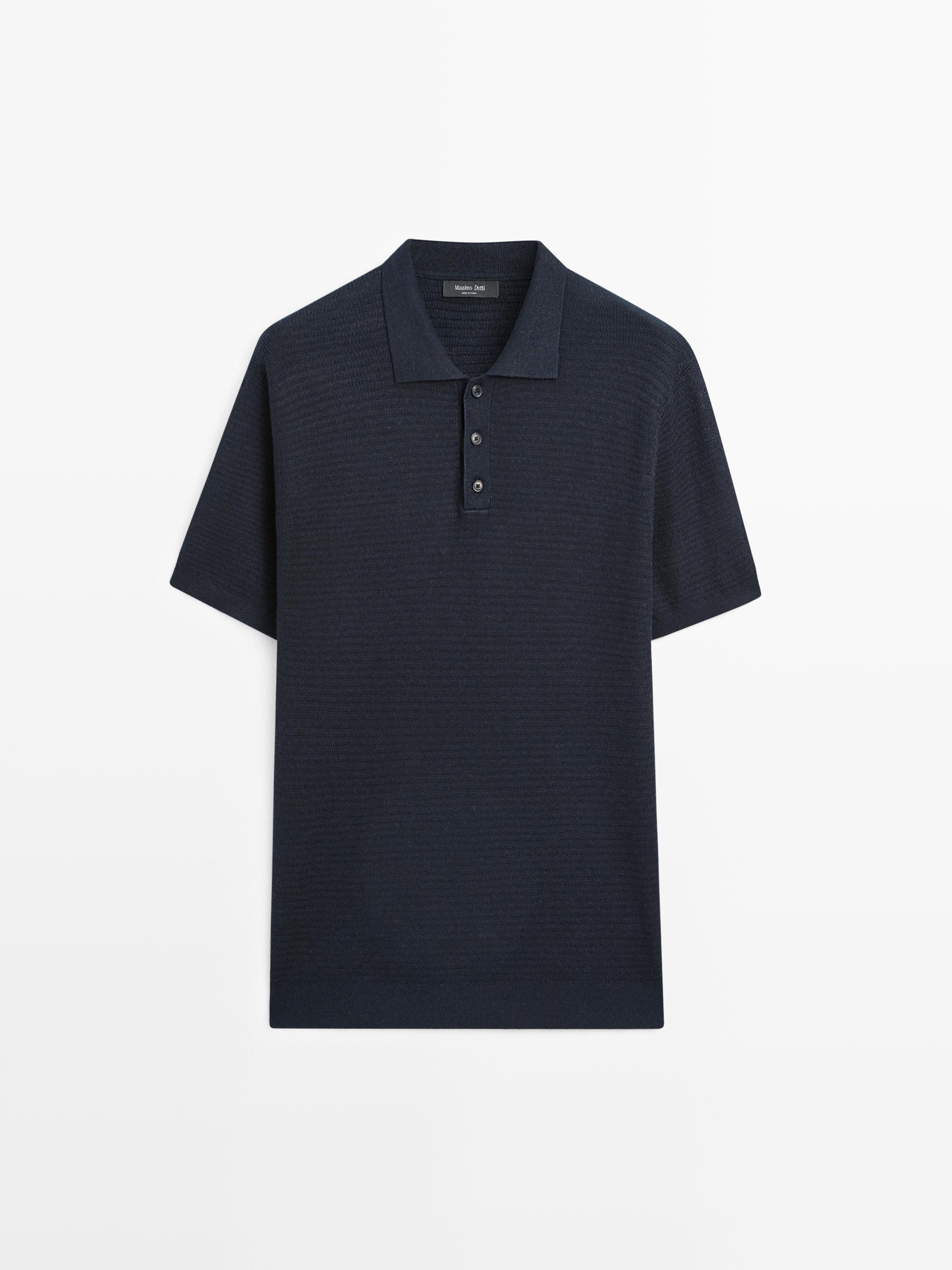 Front view of a navy blue knit polo shirt with short sleeves and a three-button collar.