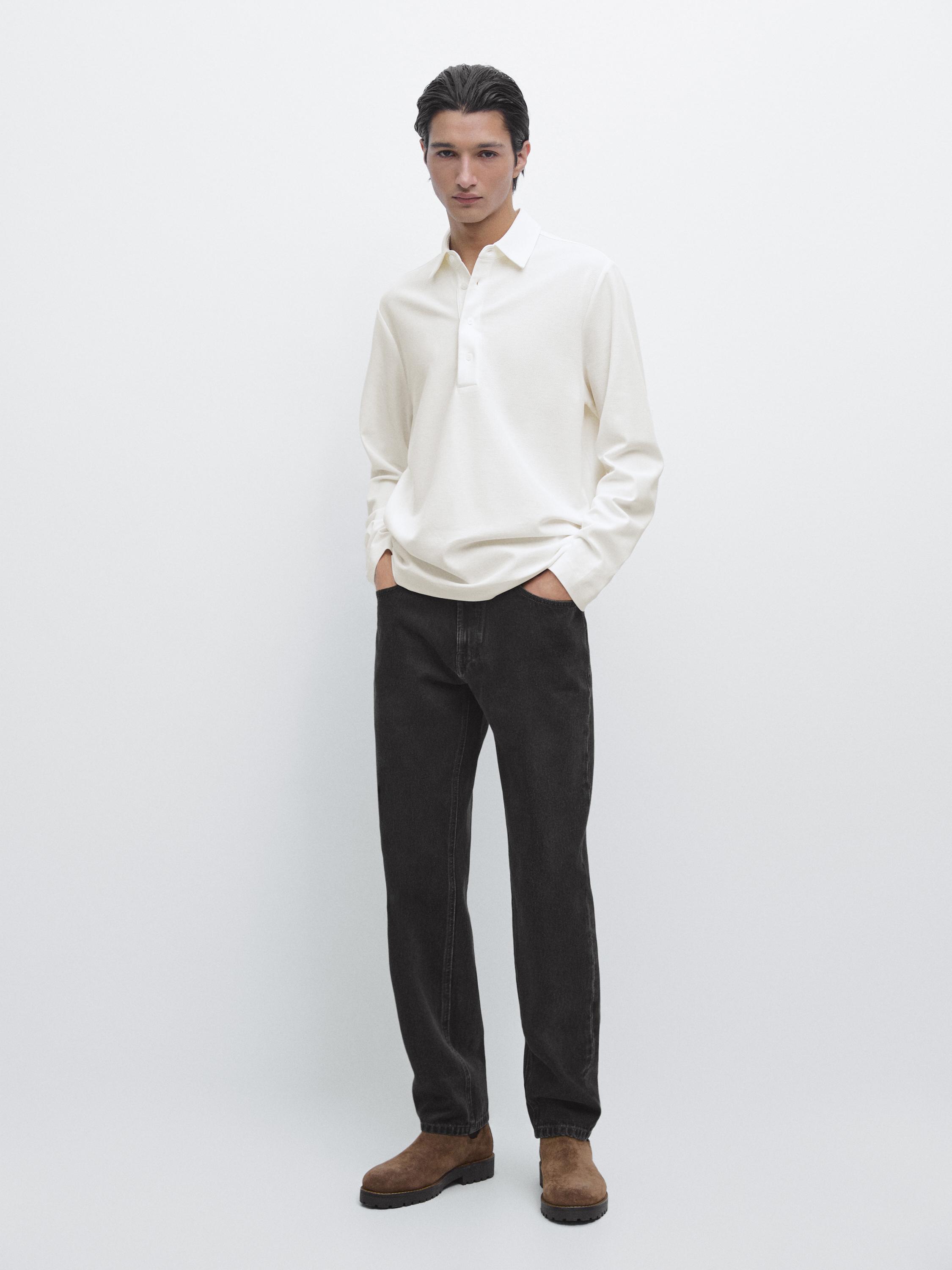 Long-sleeved white polo set with placket and dark pants.
