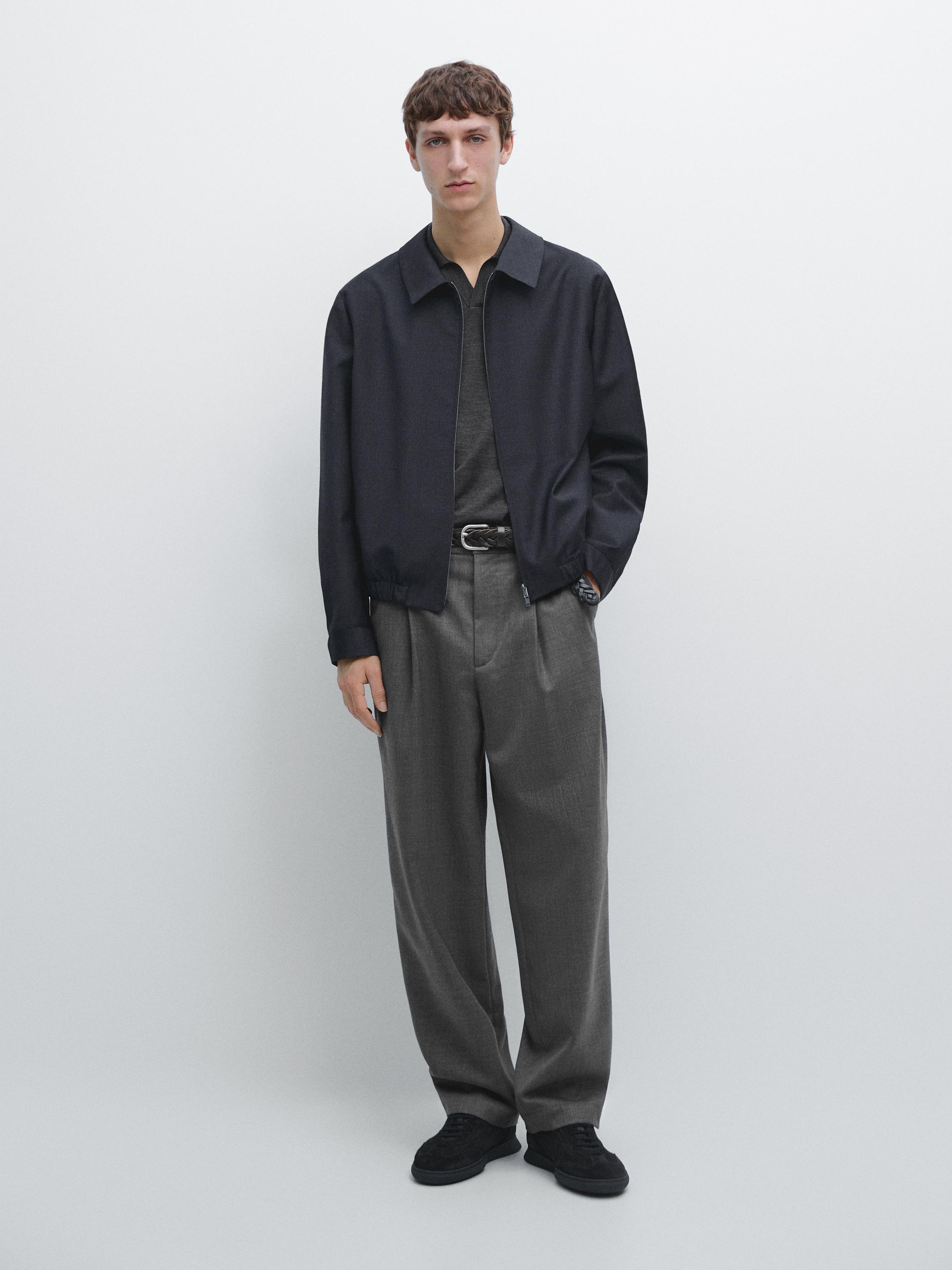 Black jacket, dark gray t-shirt, and gray relaxed fit pants with pleats and side pockets set.