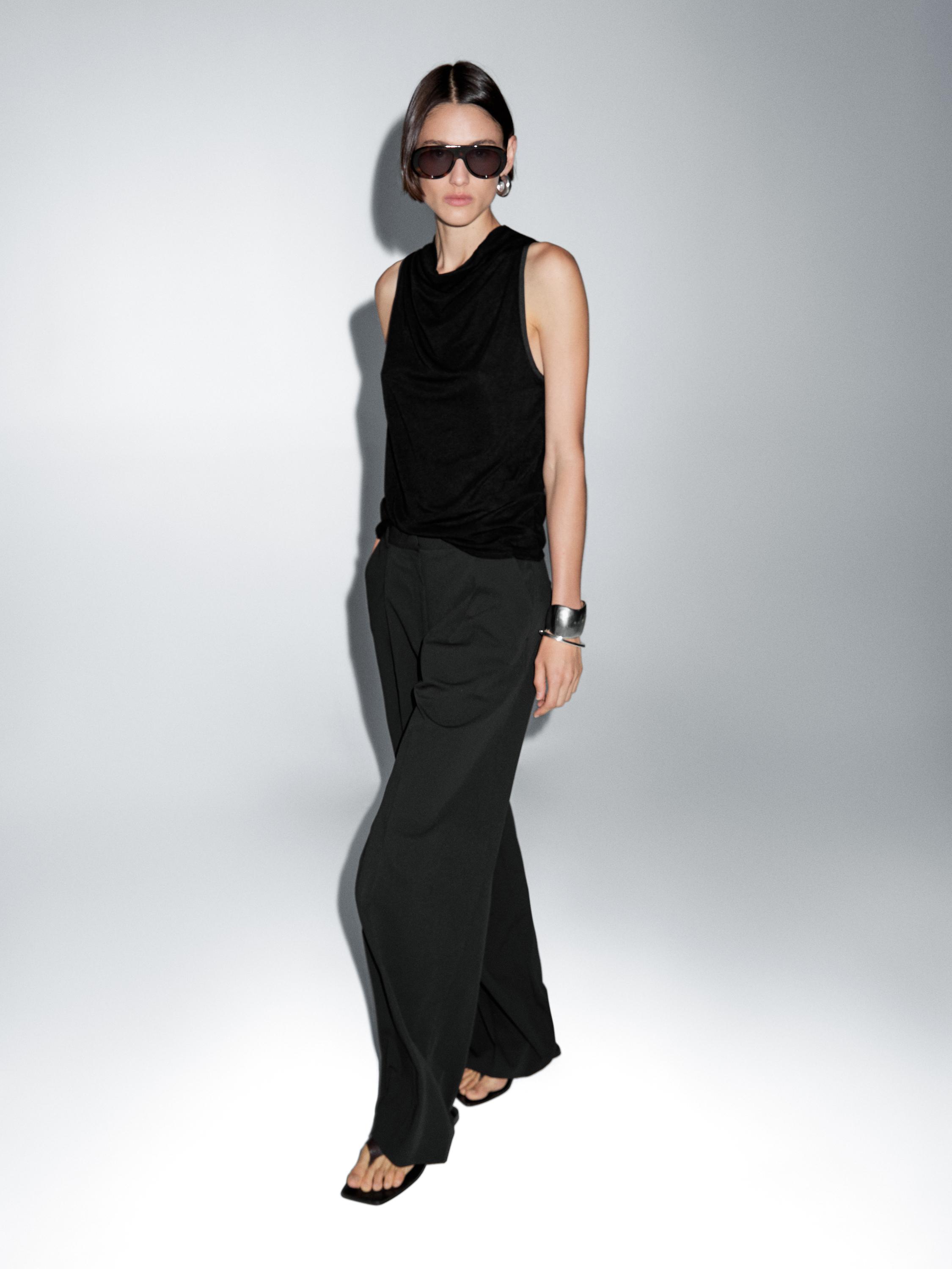 Sleeveless top with draped neckline
