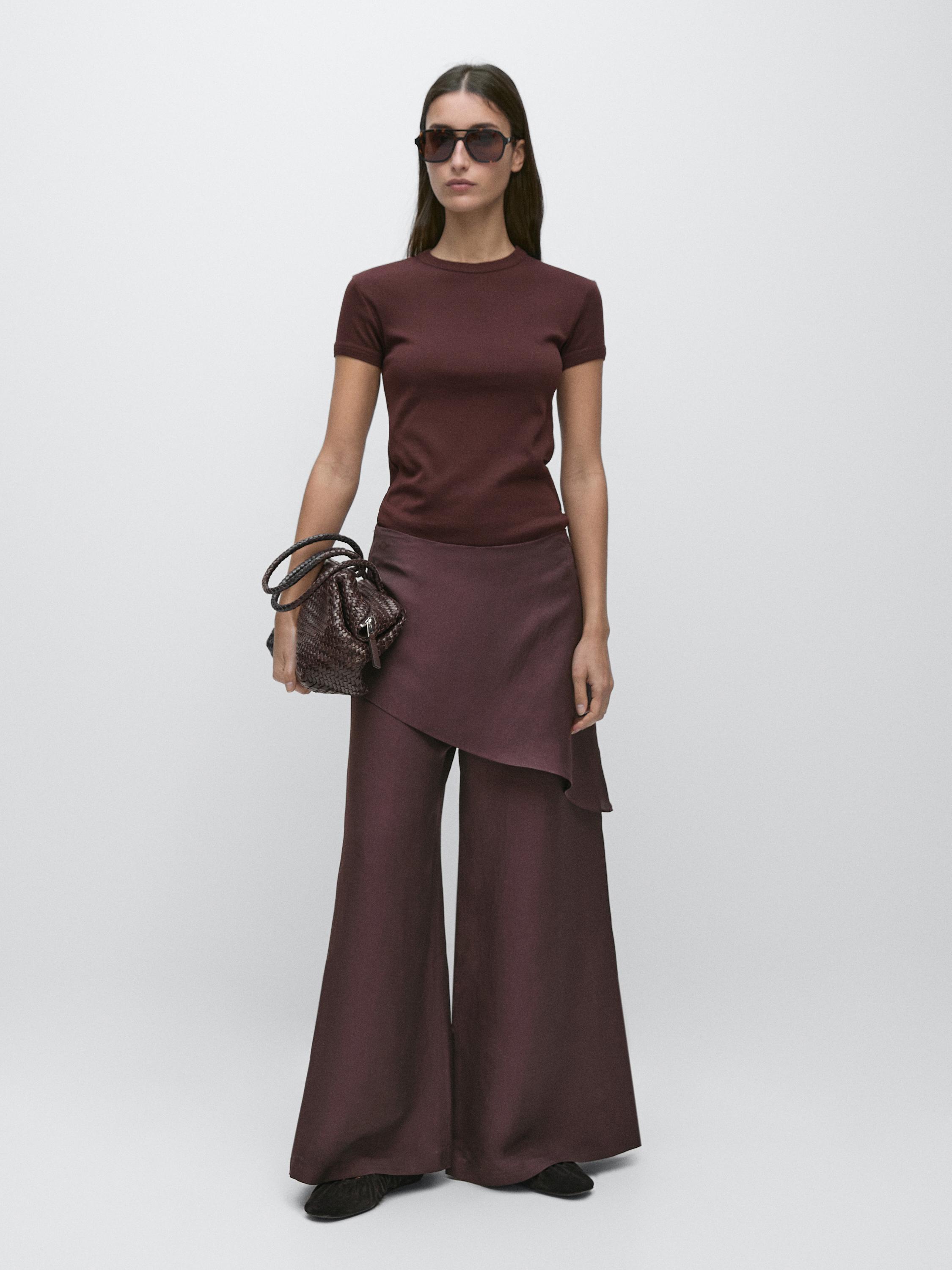 Eggplant-colored T-shirt and wide-leg pants set, with an asymmetrical overlay skirt.