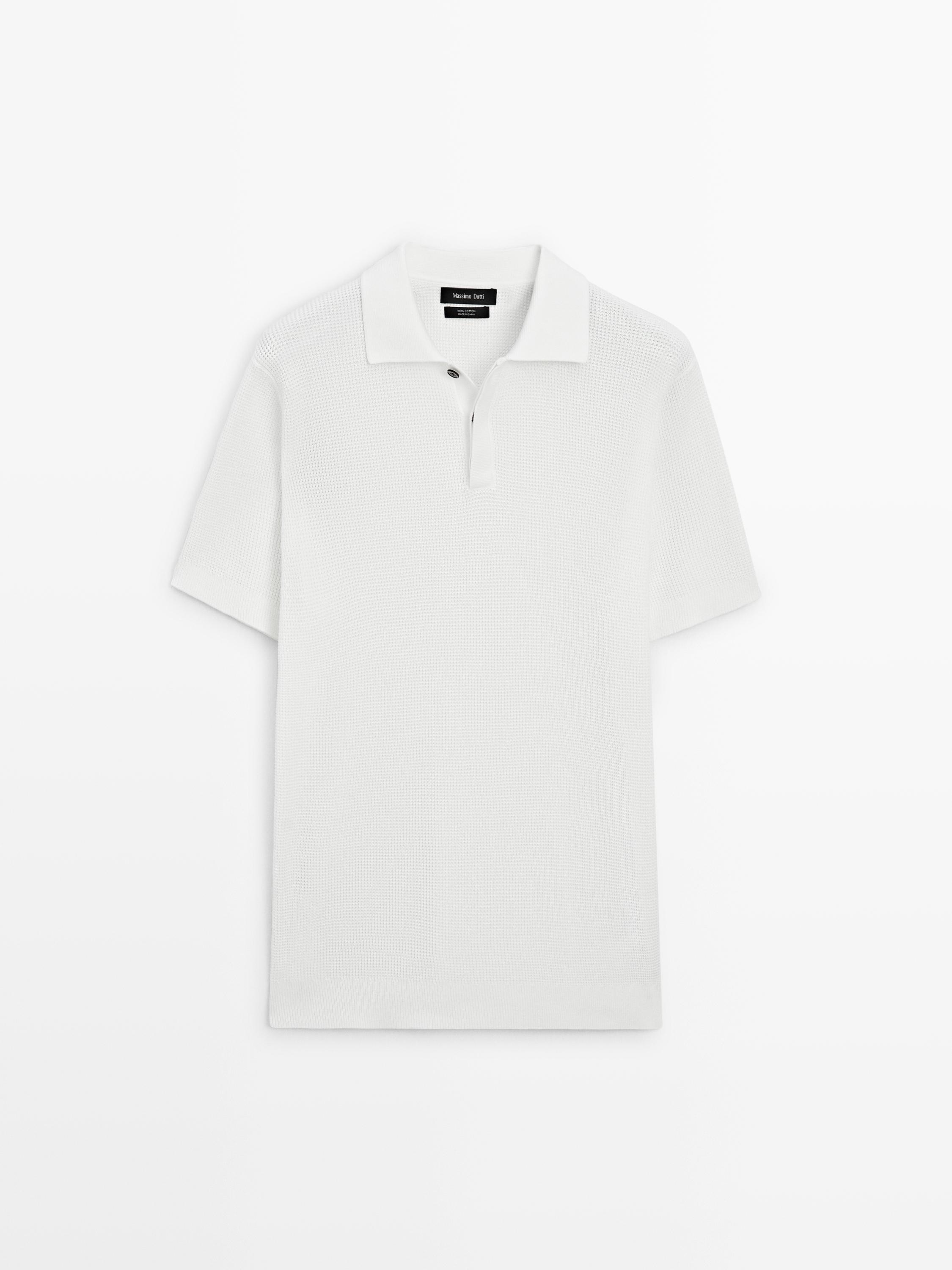 Front view of a white textured polo with classic collar and two-button closure. Short sleeves and straight cut.