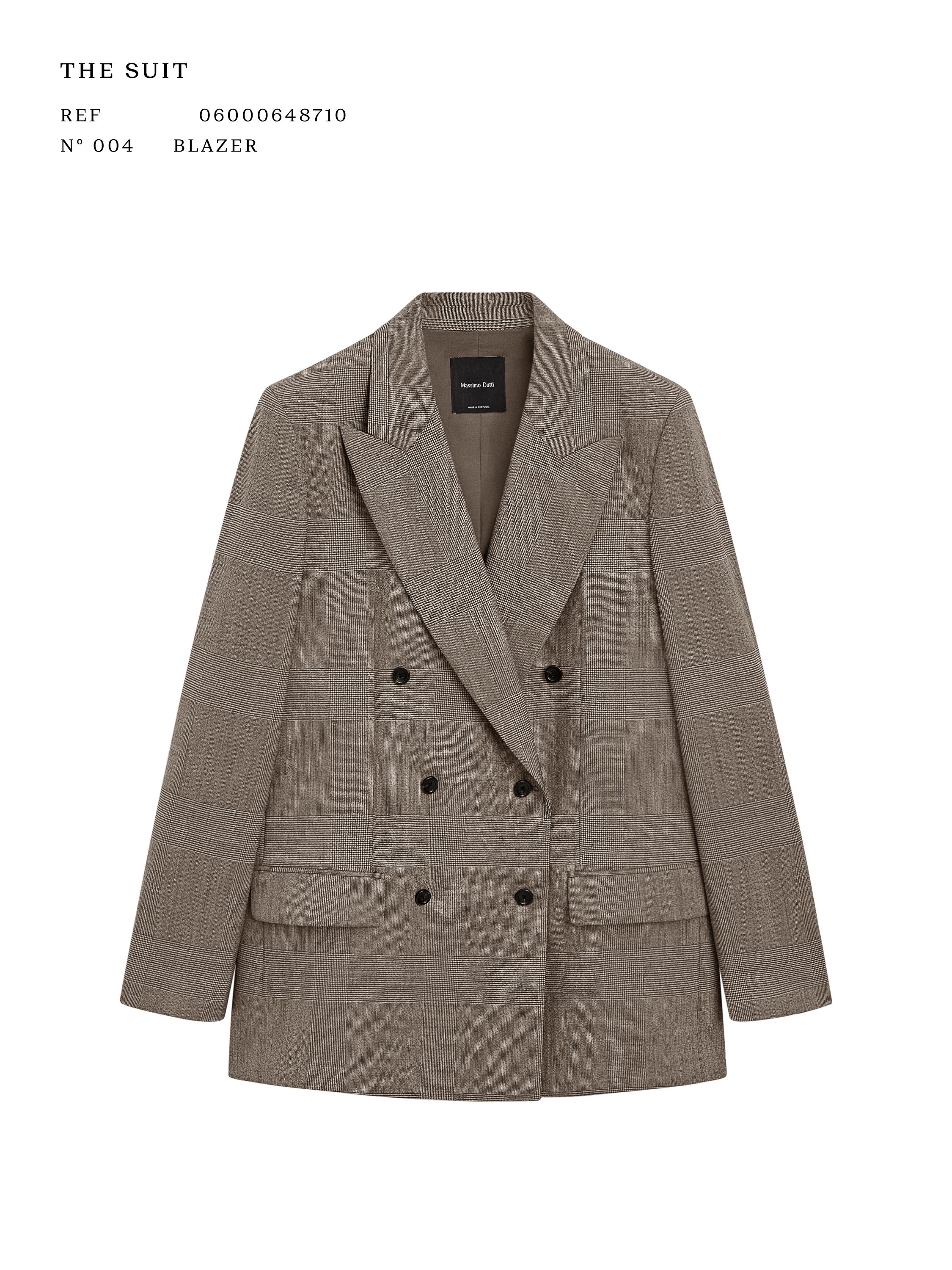 Front view of a beige double-breasted blazer with flap pockets. Visible text: "THE SUIT REF 06000648710 N° 004 BLAZER".