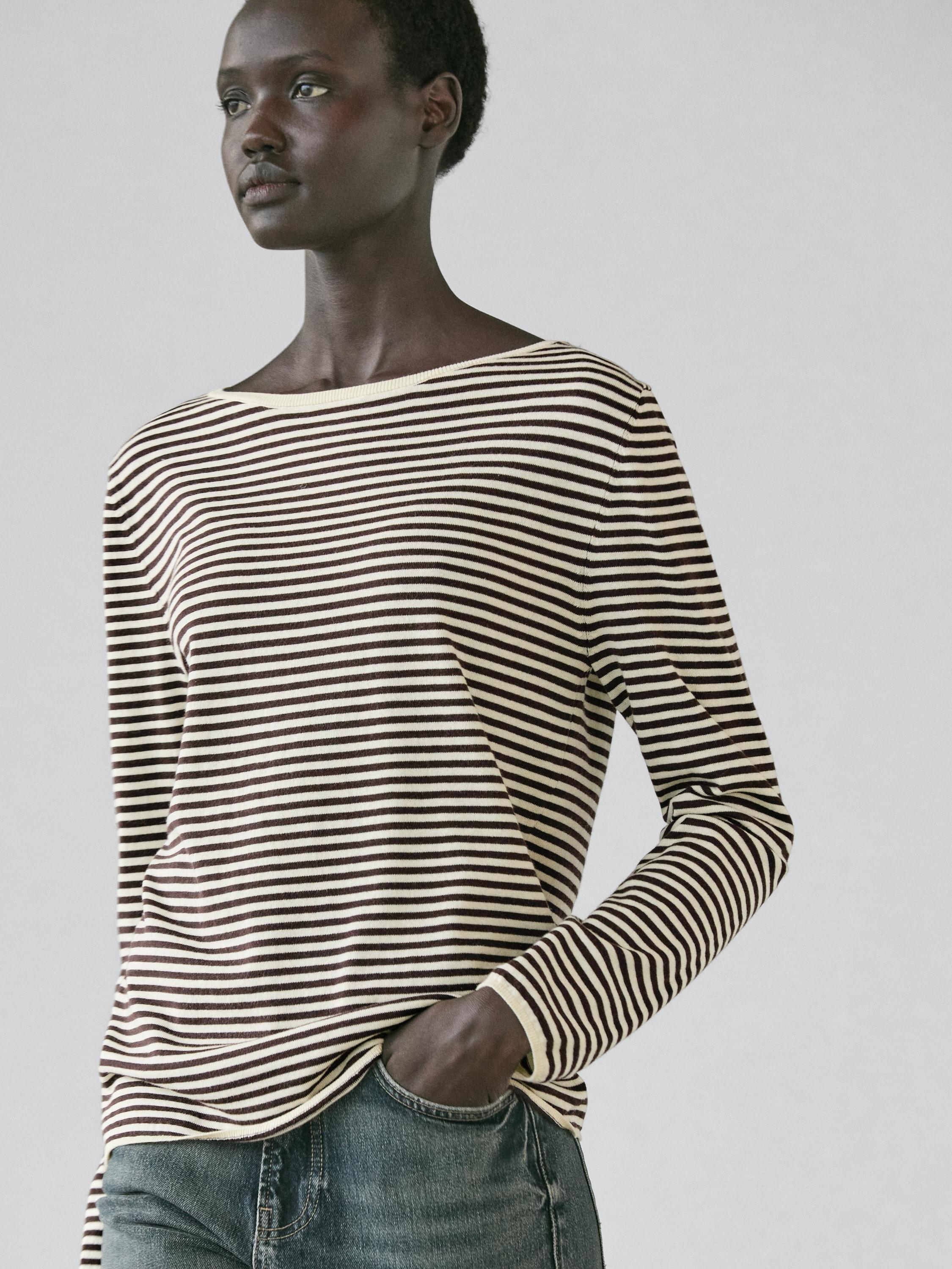 Ecru brown striped sweater set with long sleeves and jeans.