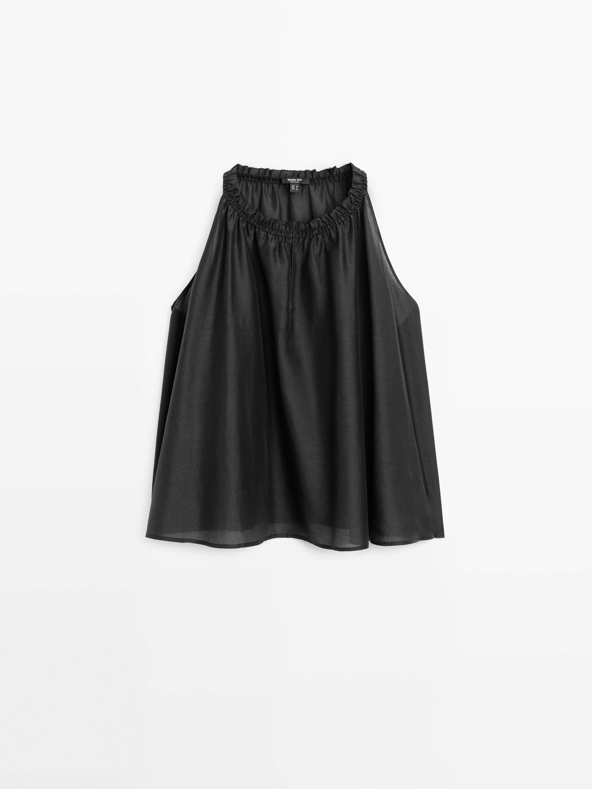 Front view of a sleeveless black top with a ruched neckline.