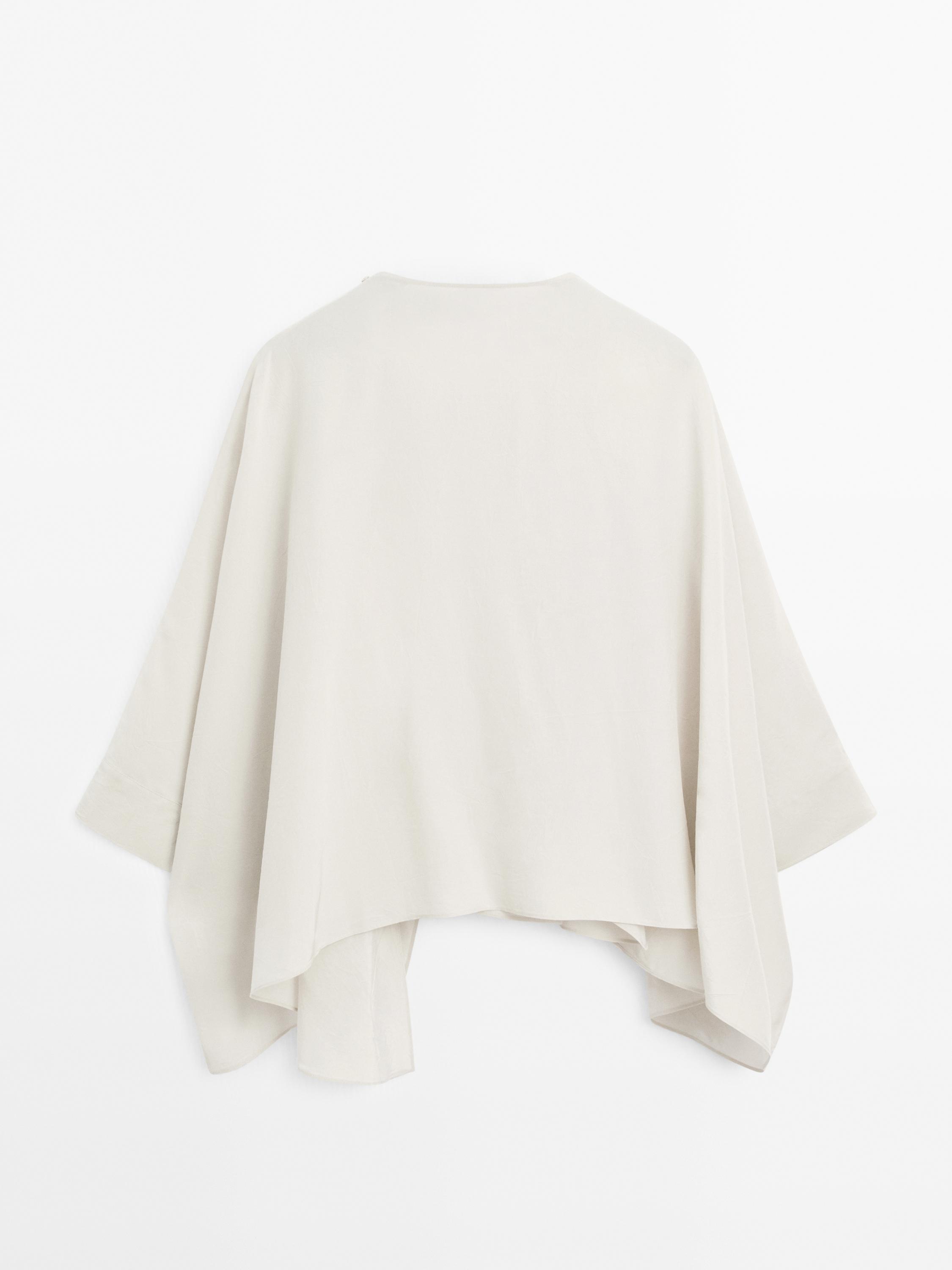 Short flowing cape with sleeve detail