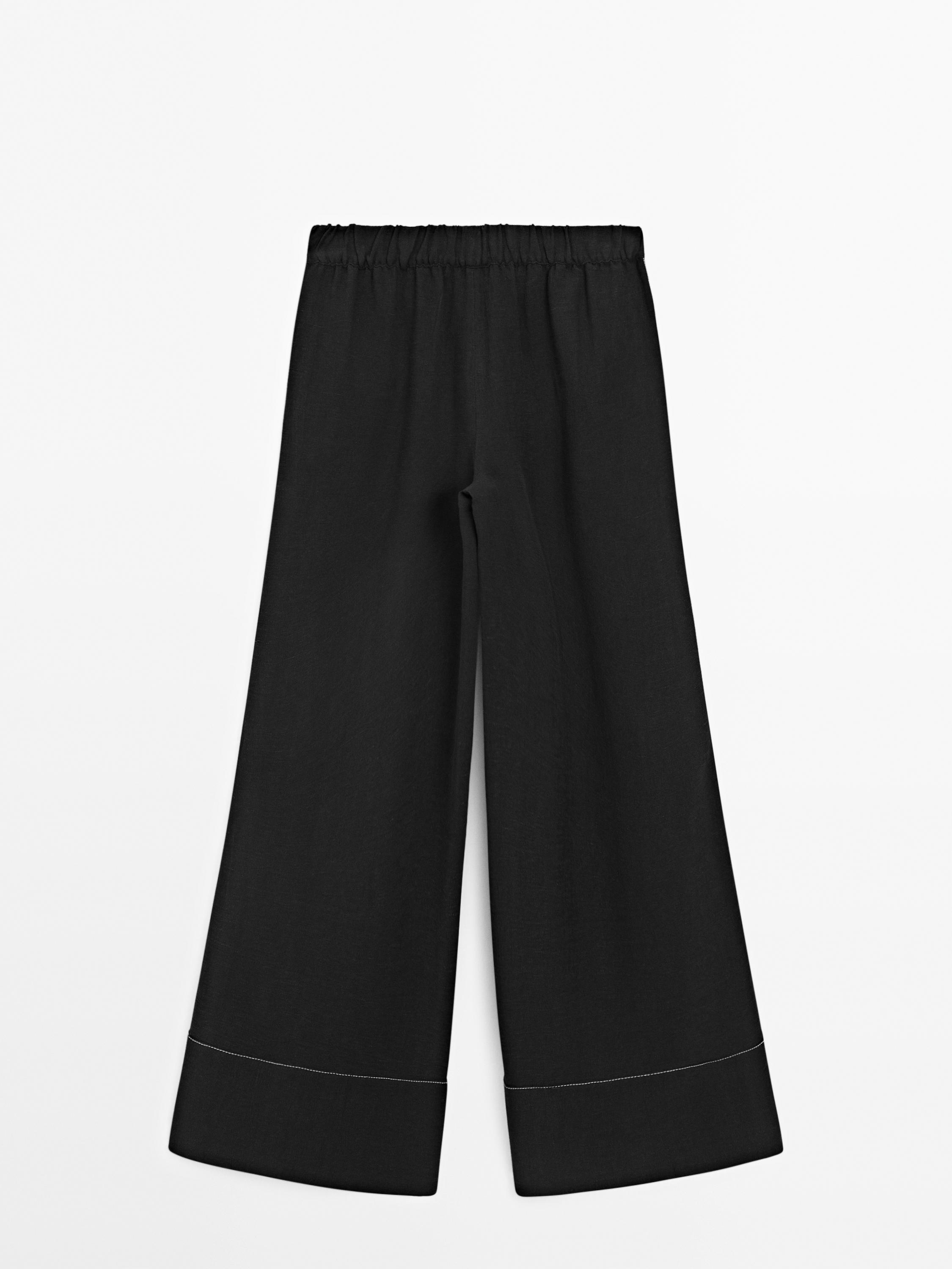 Flowing trousers with contrast topstitching