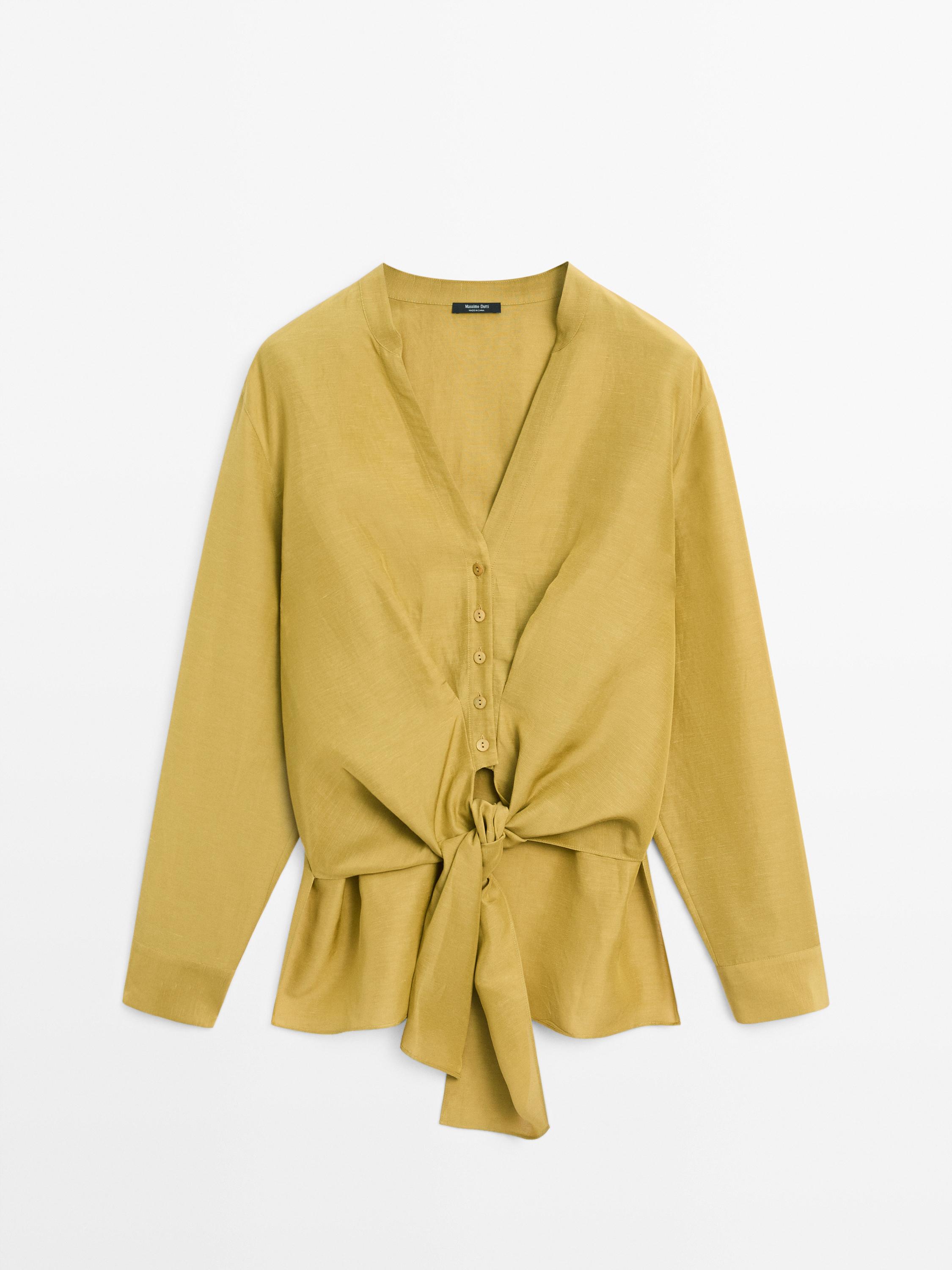 Front view of a pistachio shirt with a knot, V-neck, central button placket, and long sleeves.