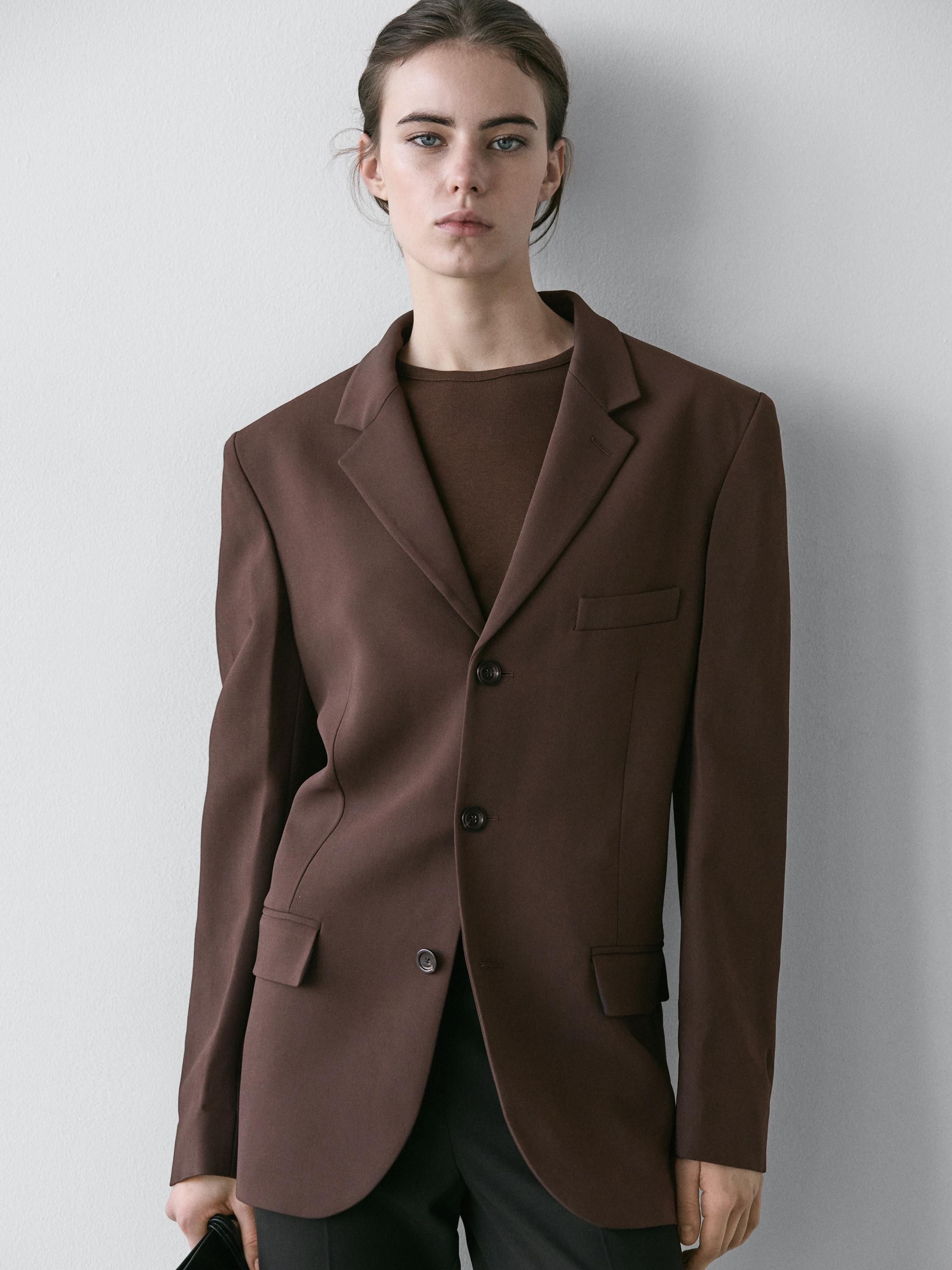 Chocolate blazer set with lapels, two-button closure, and flap pockets.