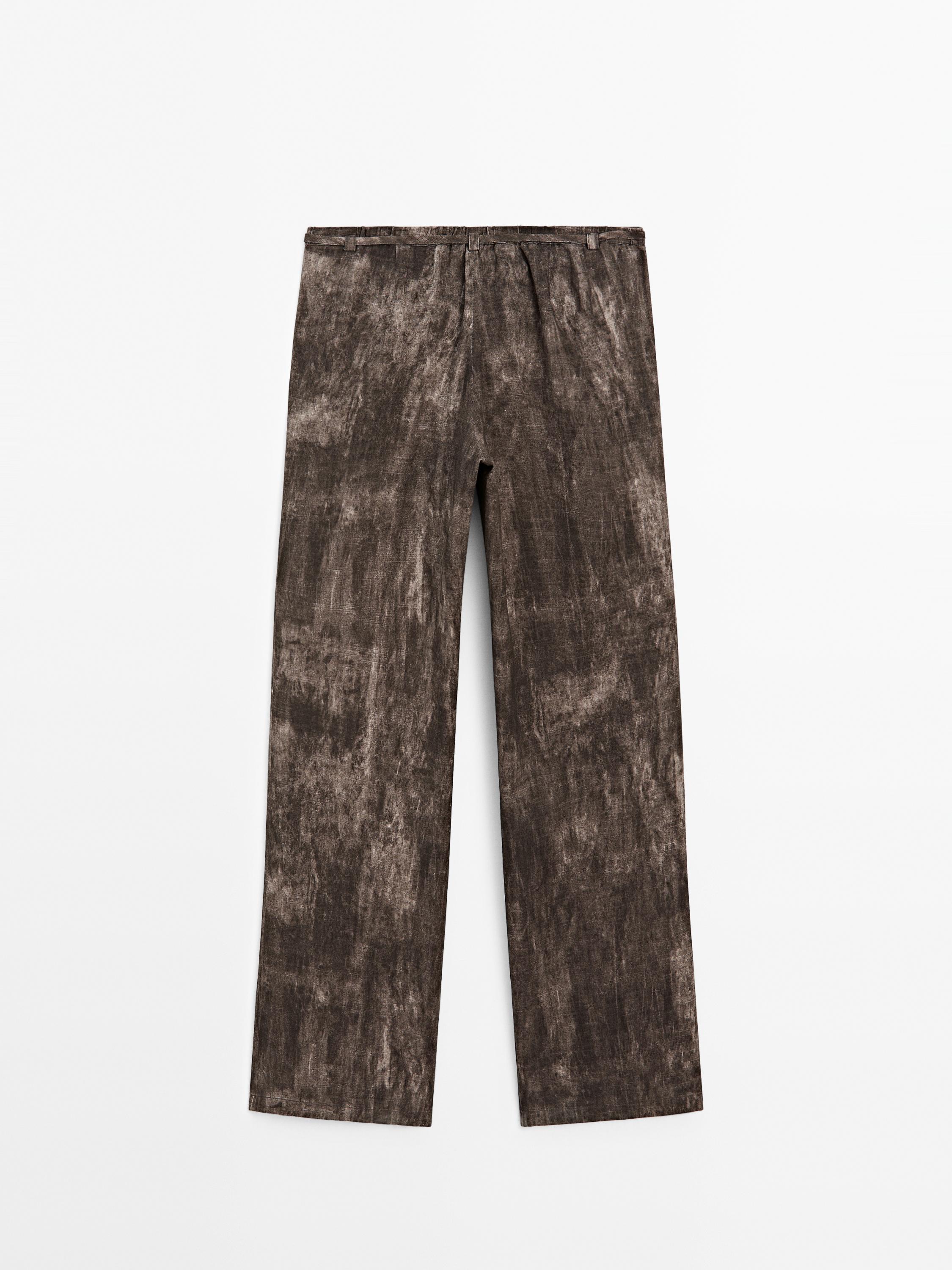 Distressed-effect flared trousers