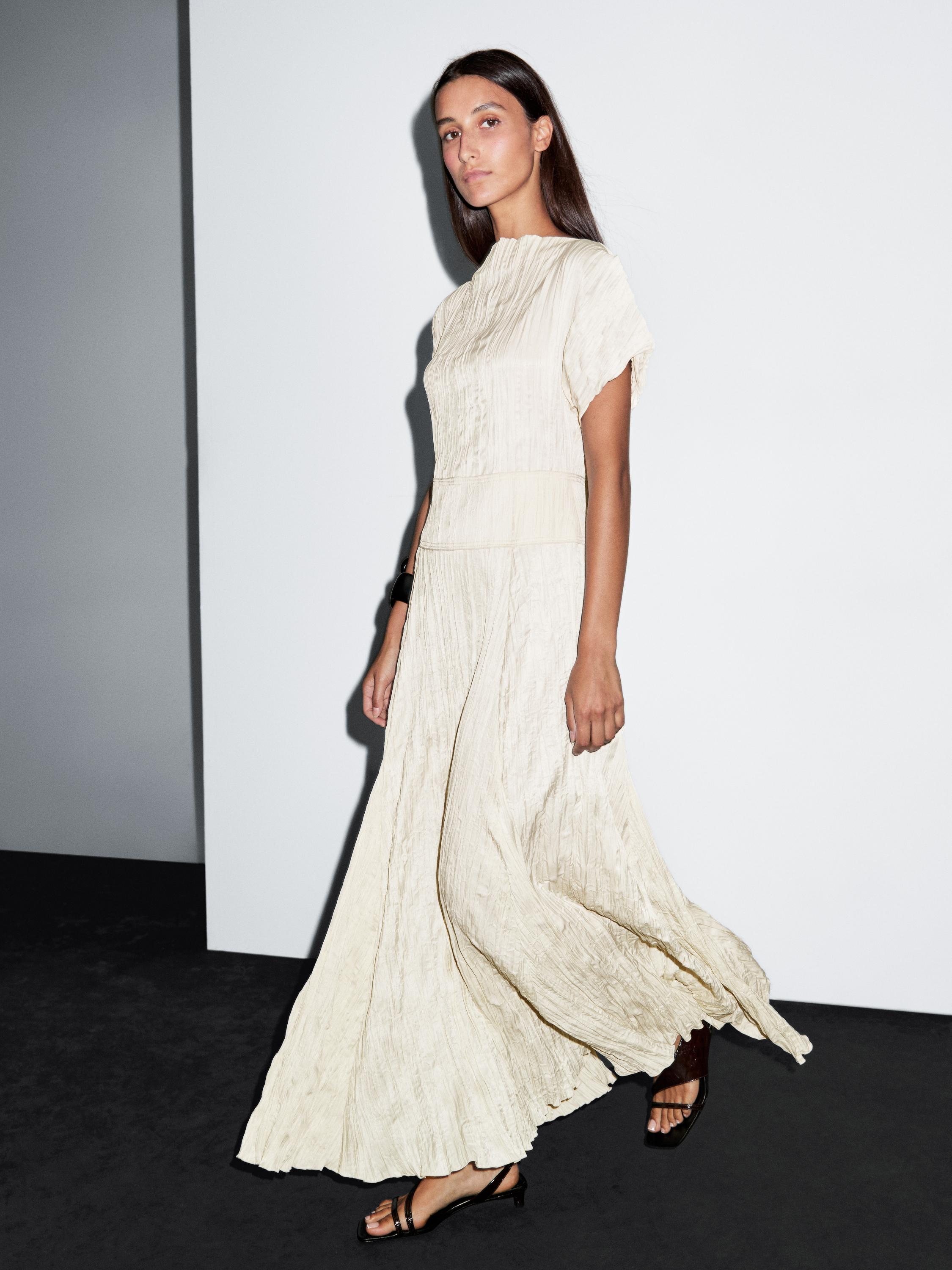 Long dress with godets and pleated detail