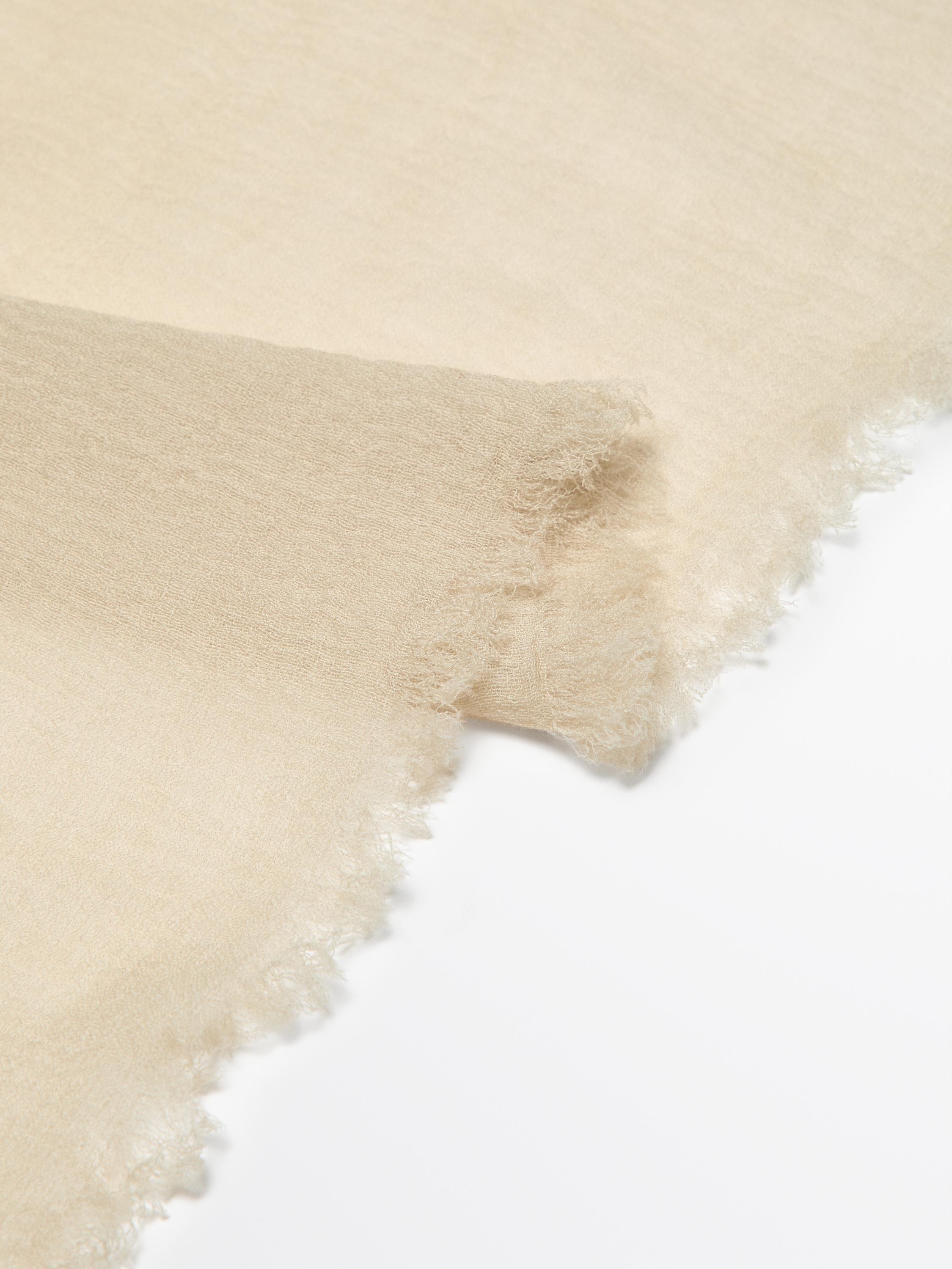 Flowing wool scarf with frayed edges