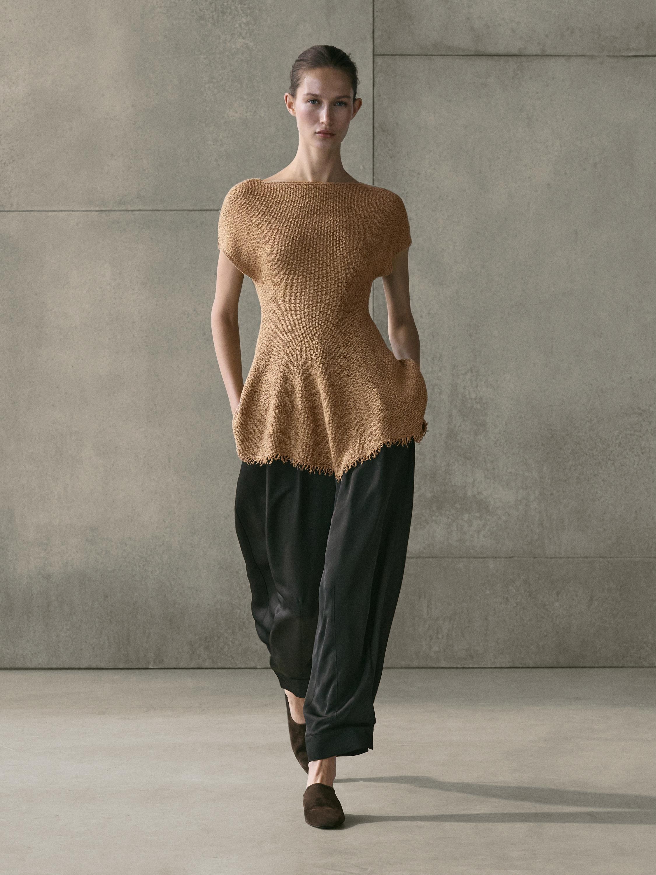 Fringed toasted top with side pockets and loose black pants set.