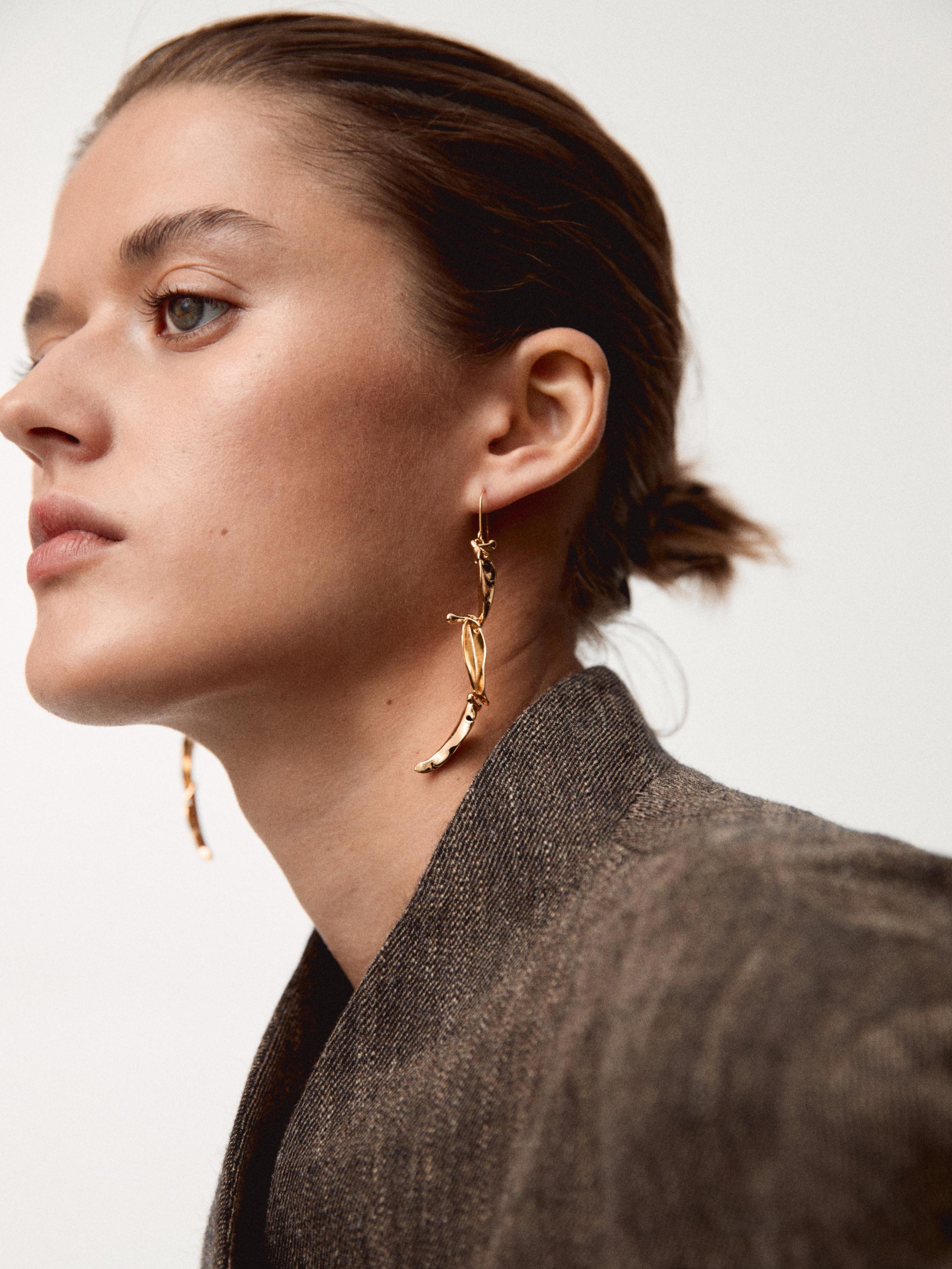 7 cm-ko urrezko belarritako luze bihurrituak.