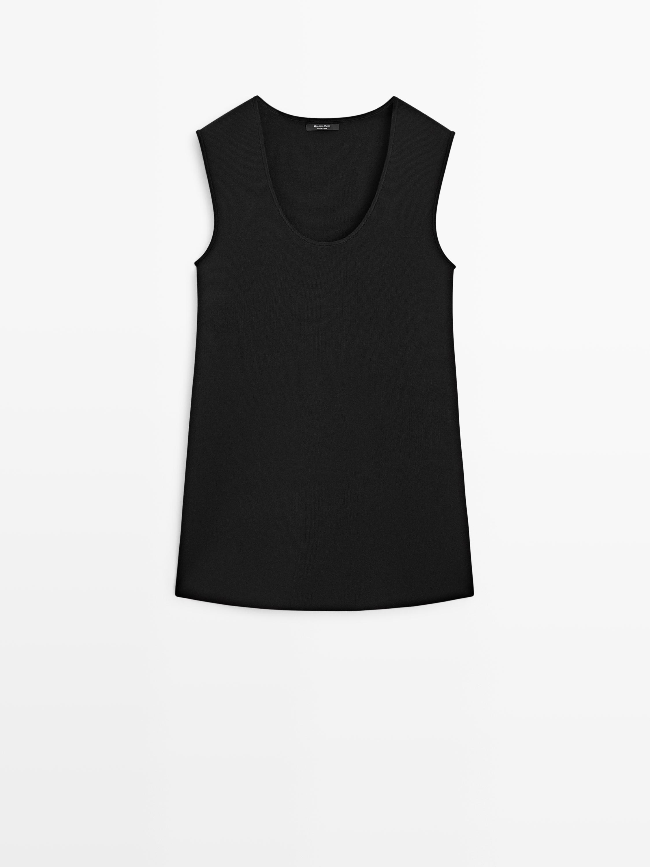 Front view of a sleeveless black mini dress with a round neckline and a fluid cut.