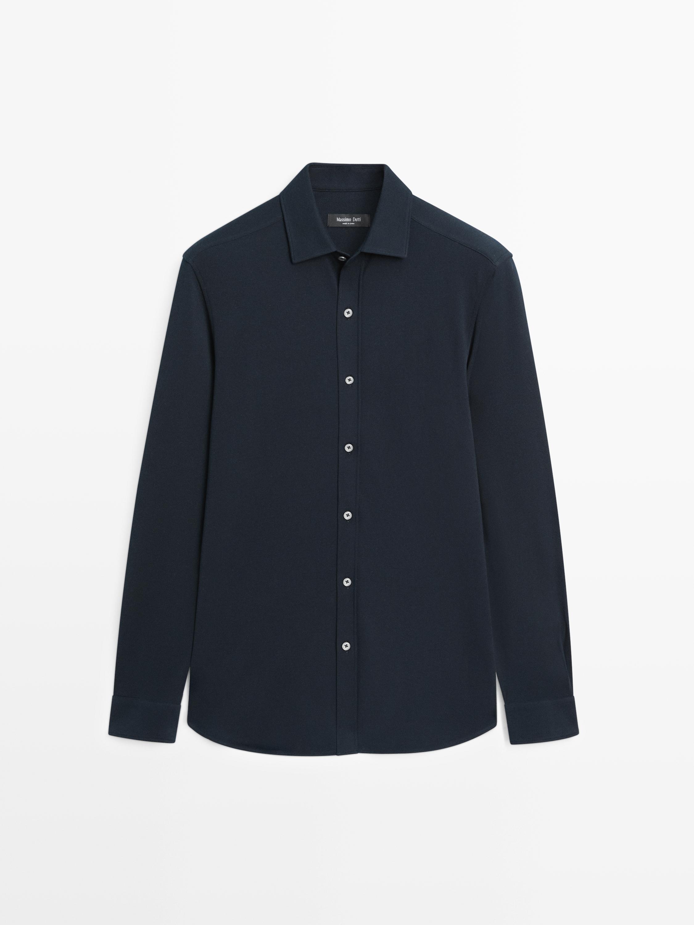 Front view of a navy blue long-sleeved shirt with a central button placket and a classic collar.