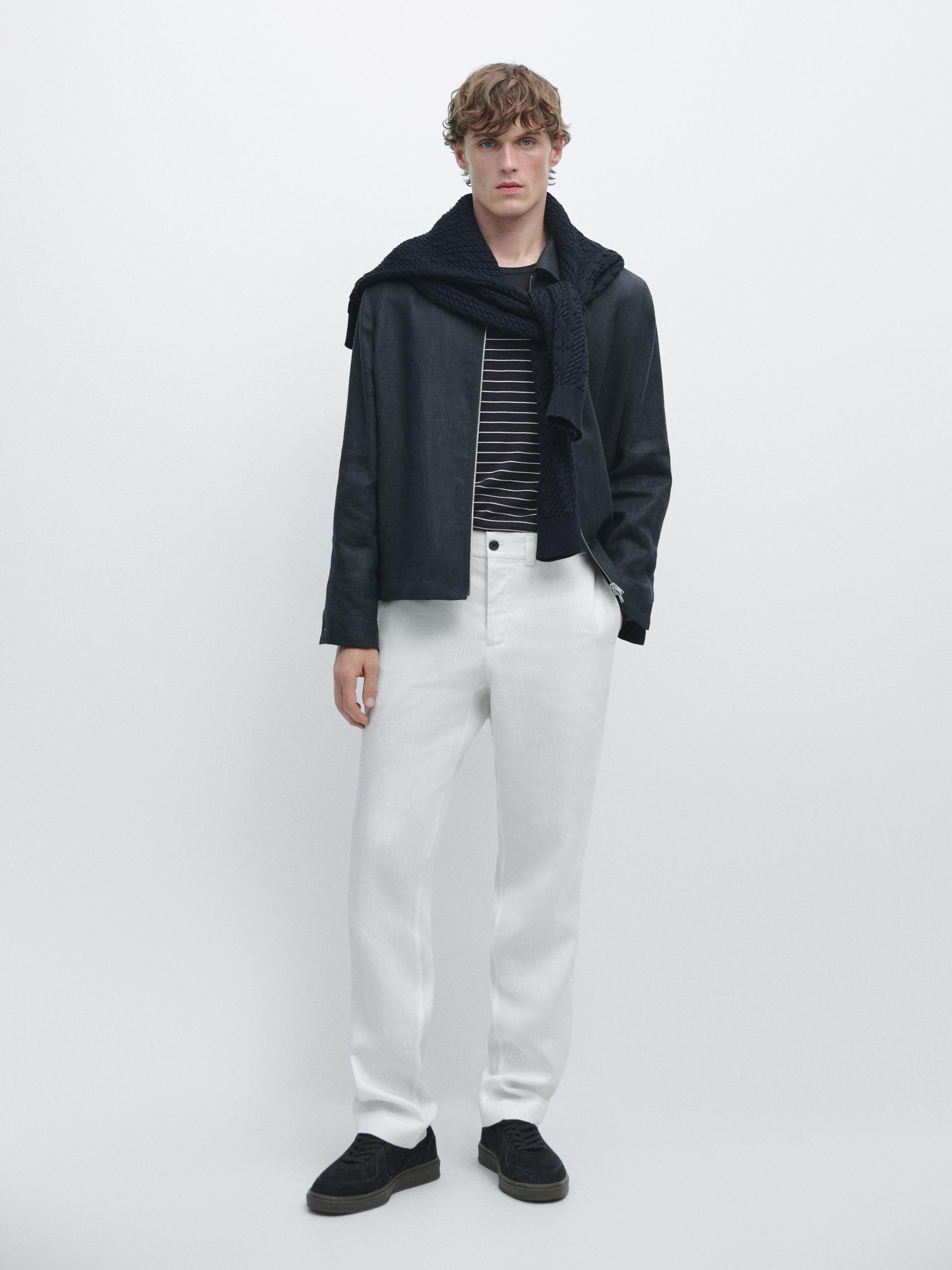 White pants set with elastic waist, striped t-shirt, black jacket, and knitted scarf.