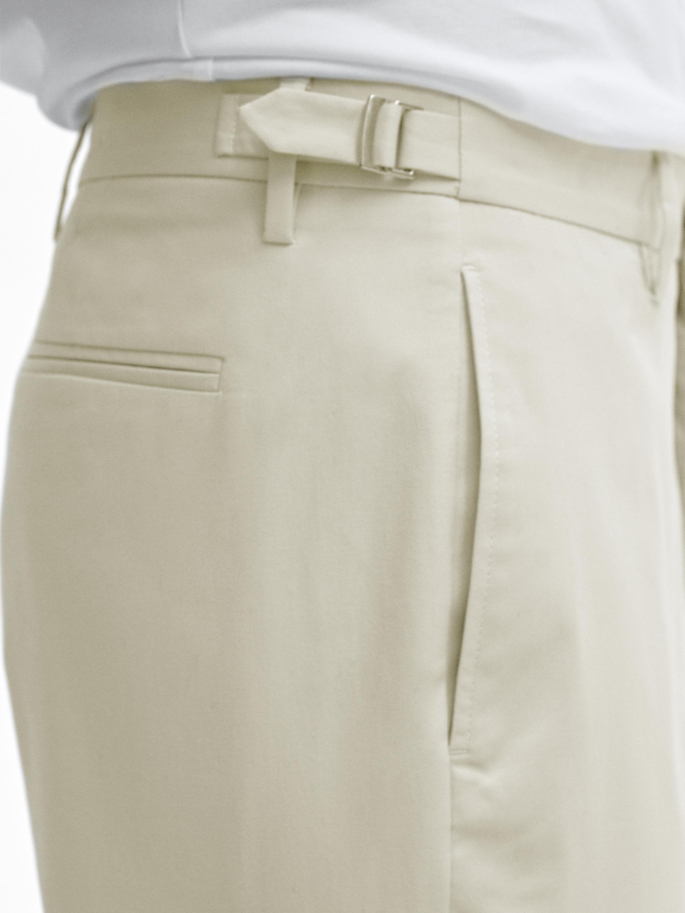Tapered fit trousers with buckle detail
