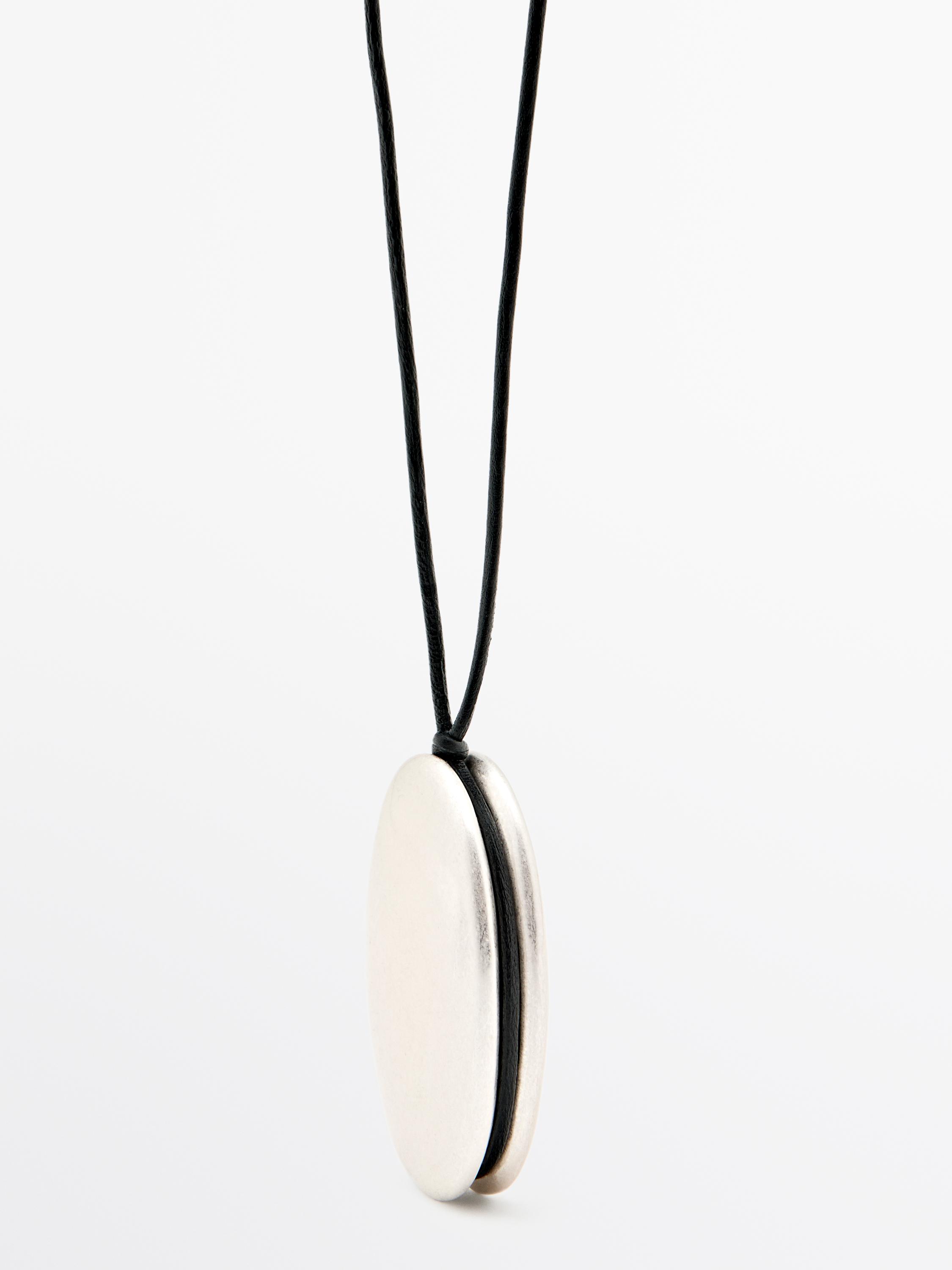 Silver oval pendant necklace with a black cord.