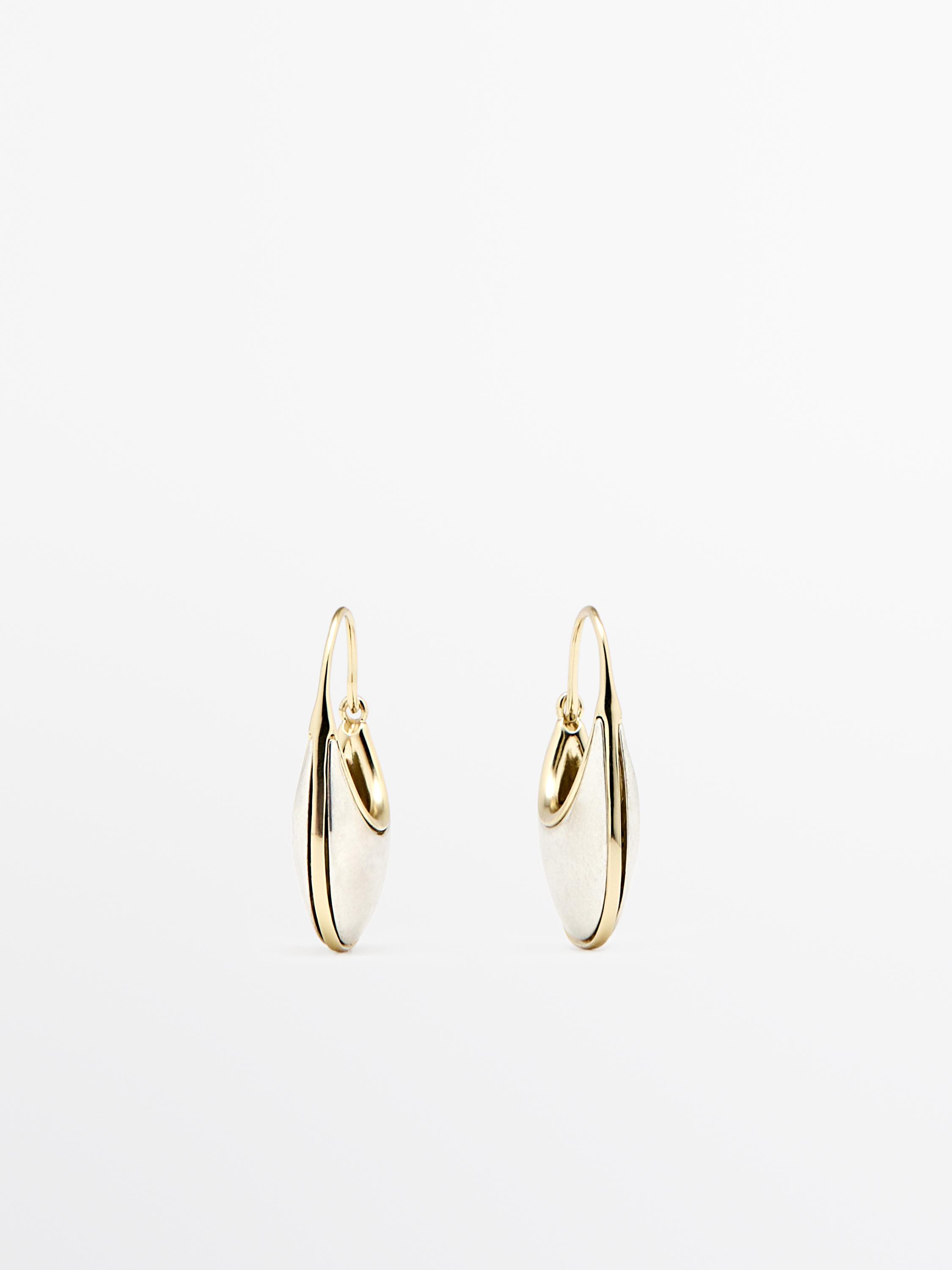 Gold hoop earrings with an oval design and embossed details.
