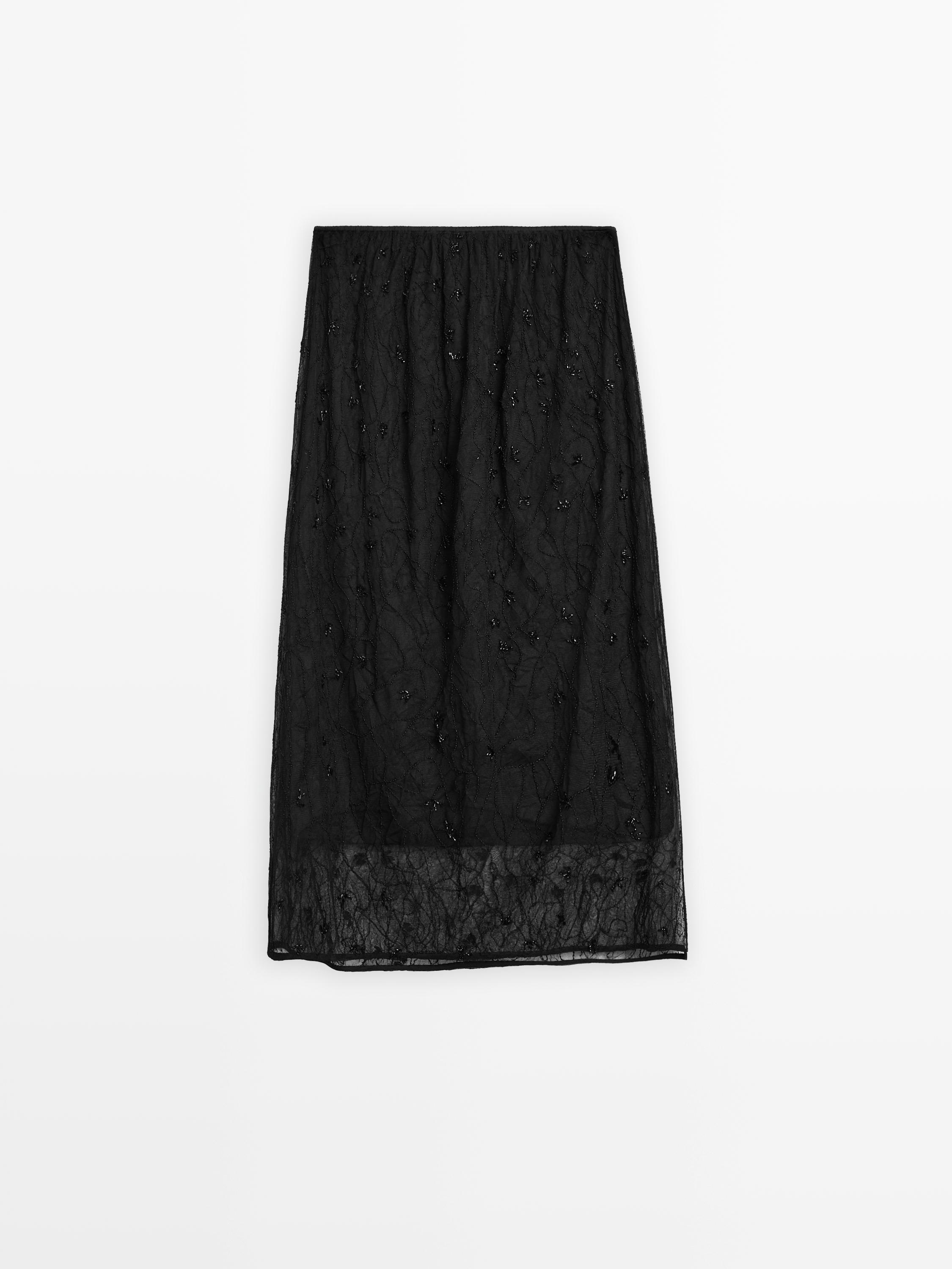 Jupe midi semi-transparente à pierres fantaisie