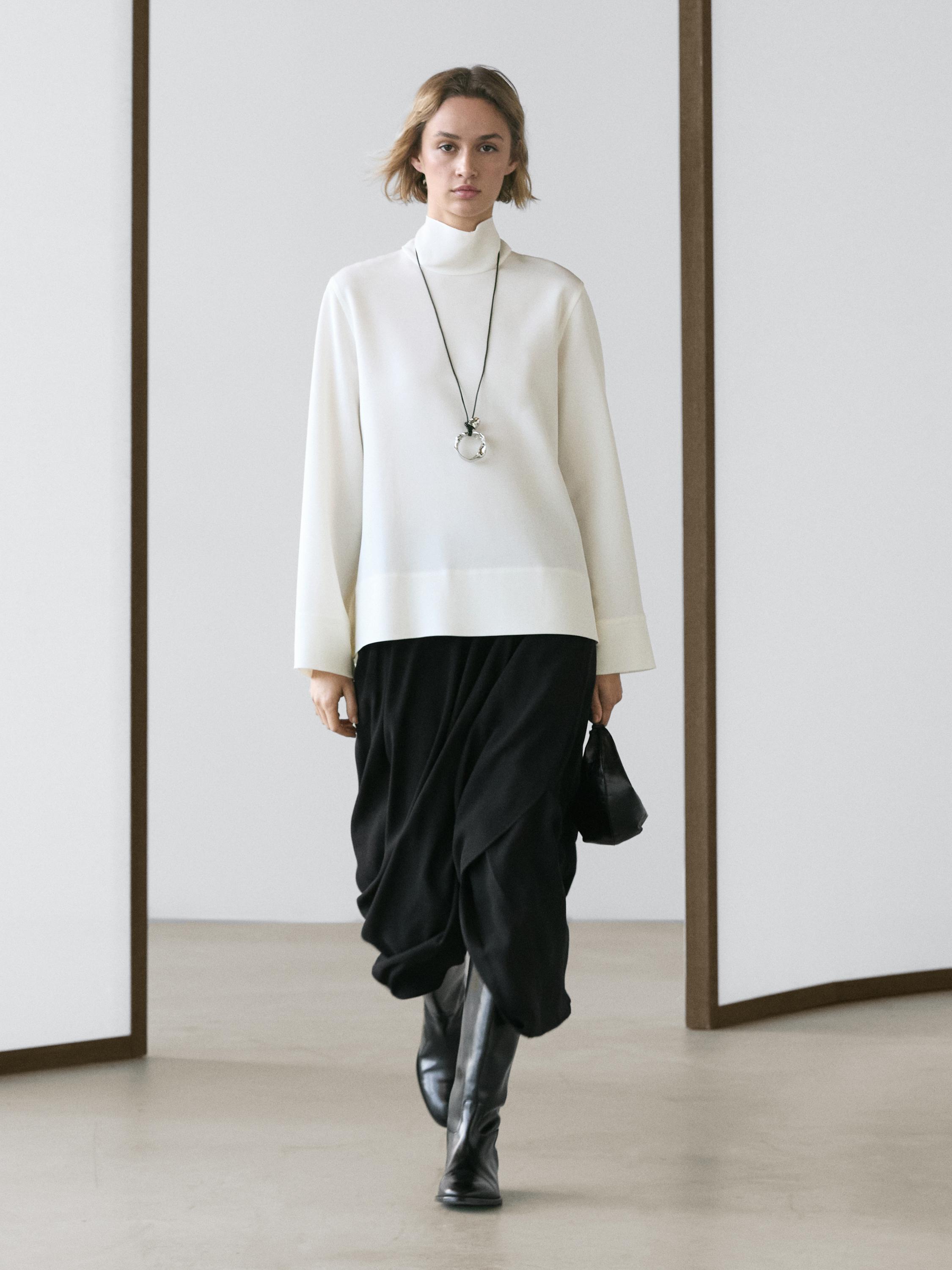 High-neck blouse with low detail