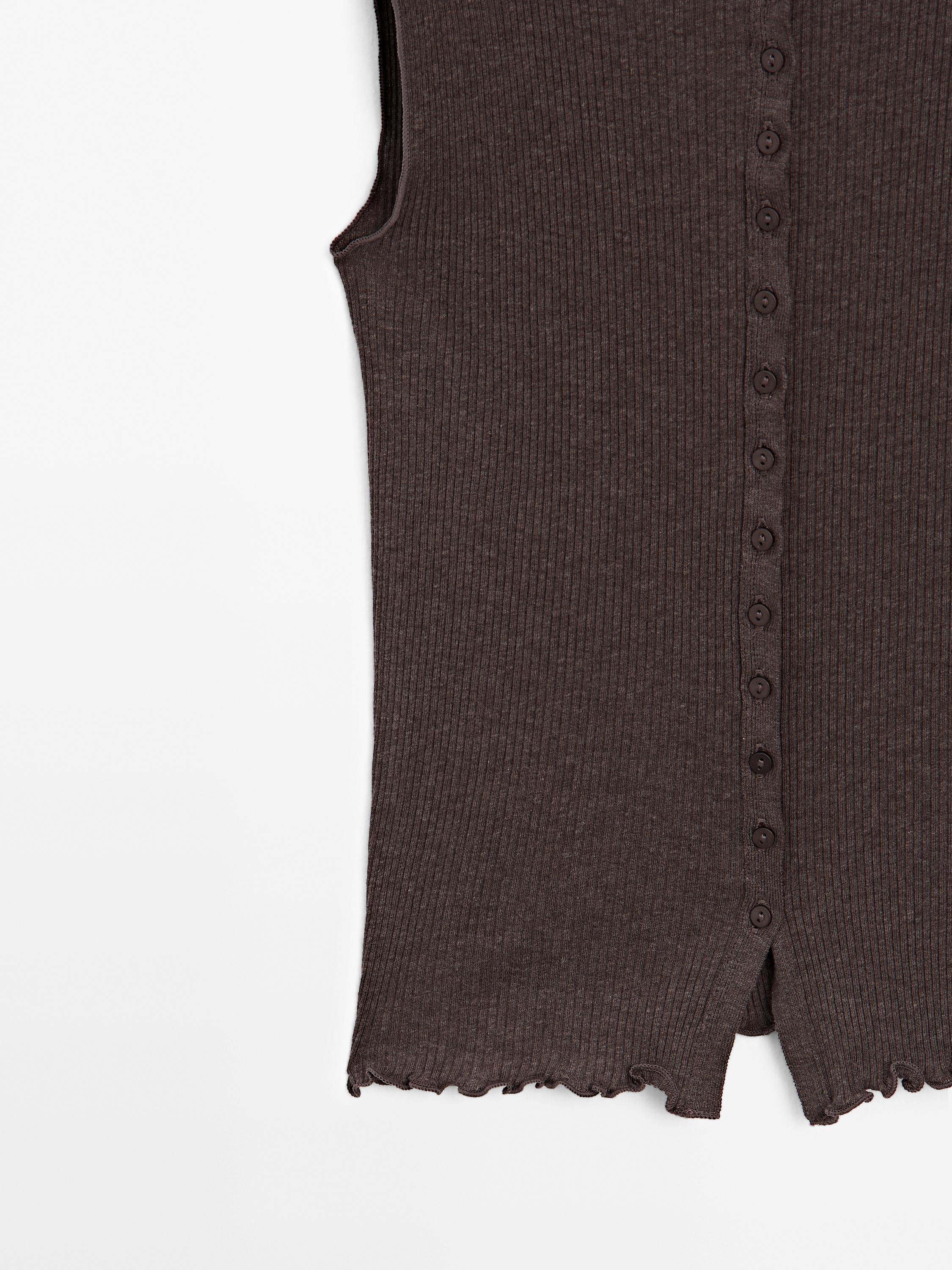 Knit waistcoat top with buttoned strap
