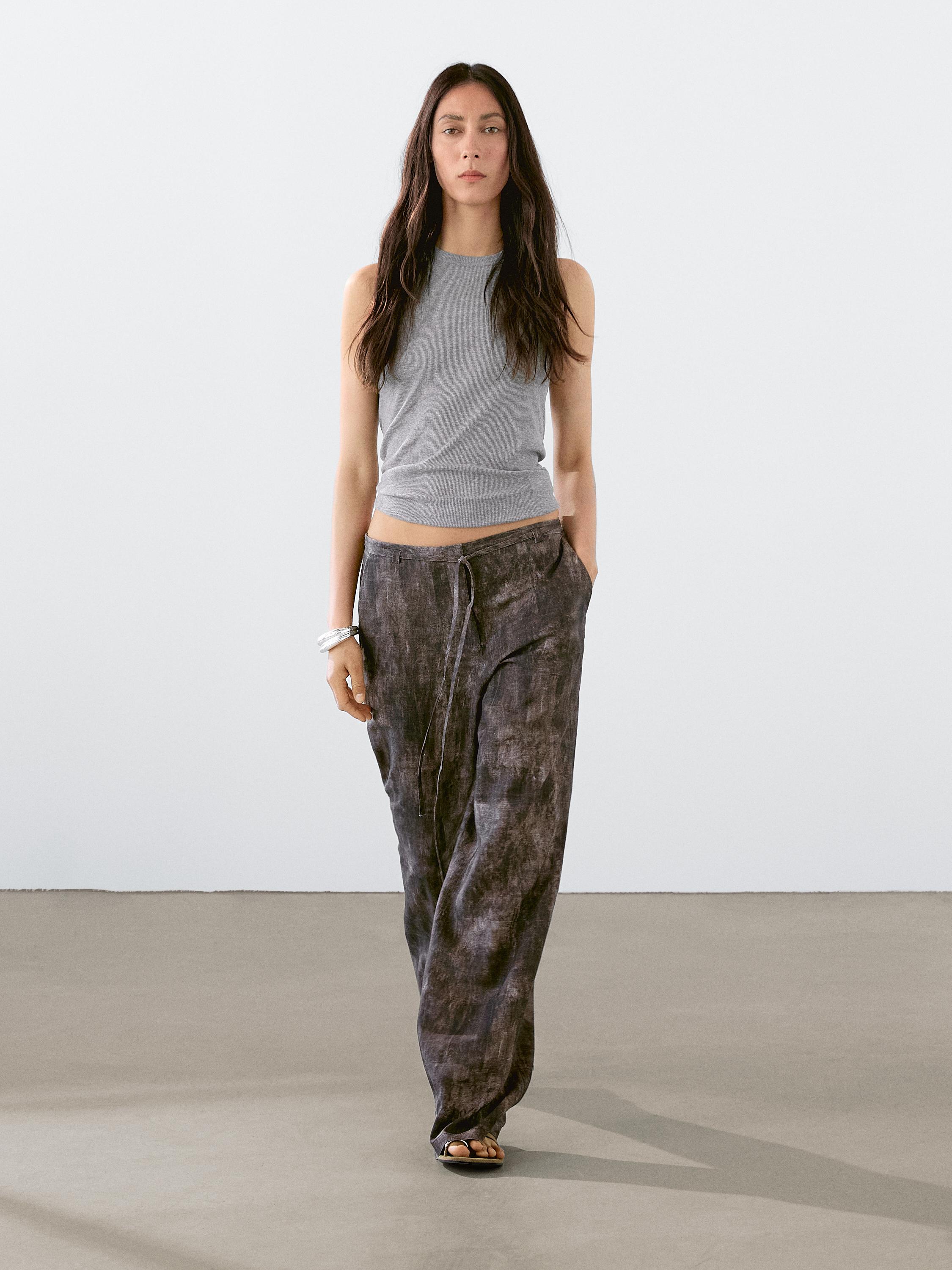 Distressed-effect flared trousers