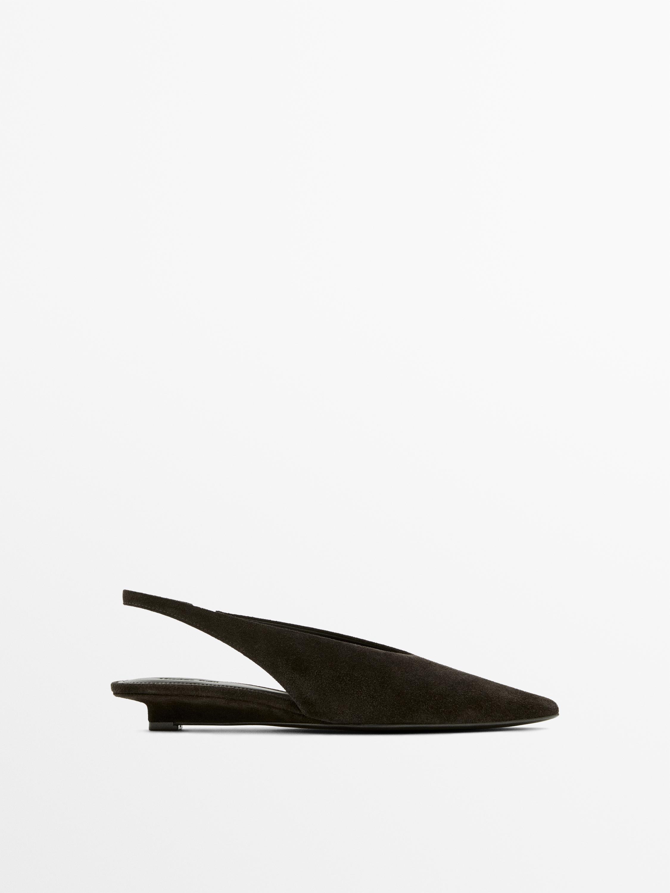 Side view of a brown backless shoe with a pointed toe and low heel.