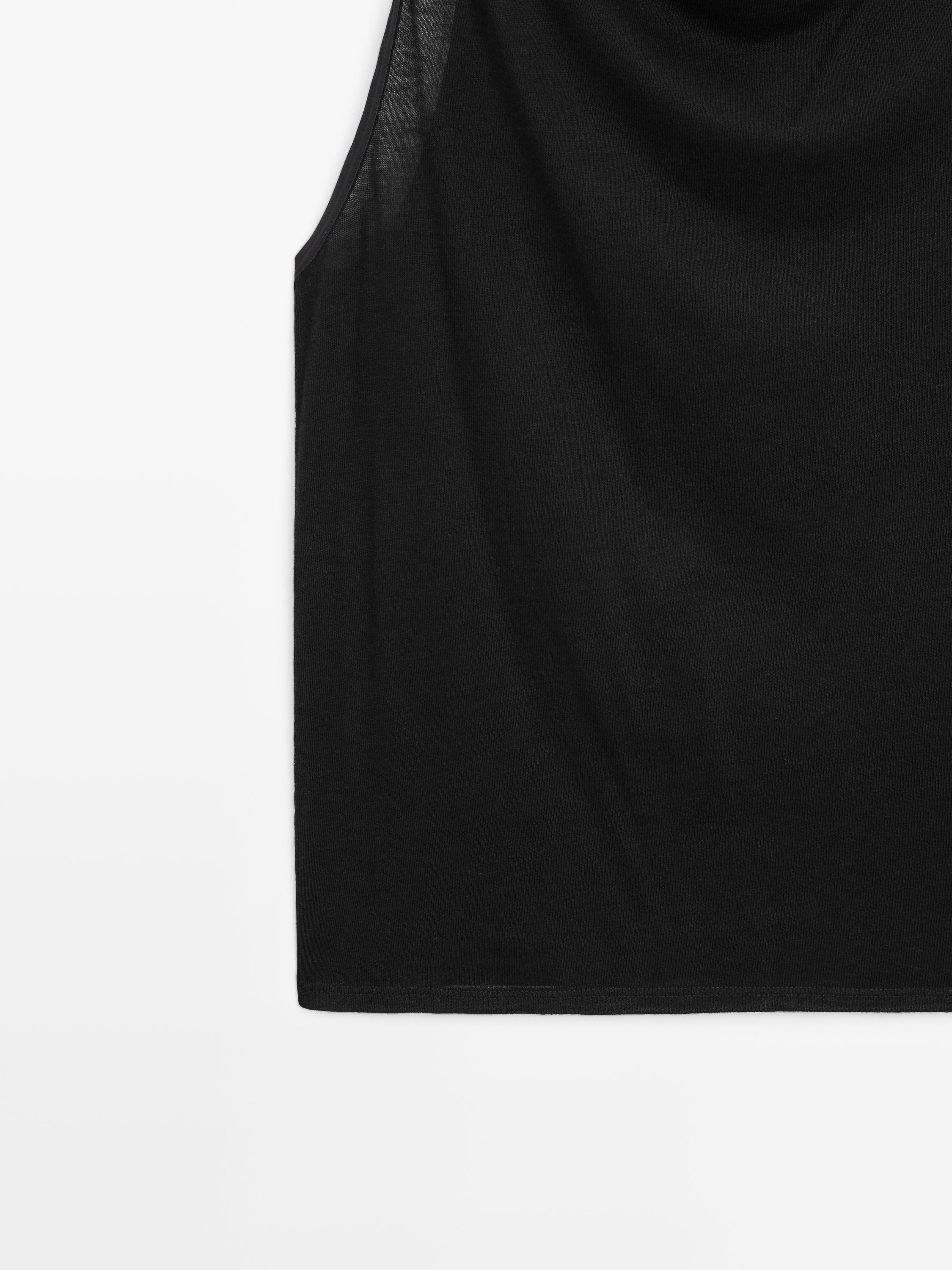 Sleeveless top with draped neckline
