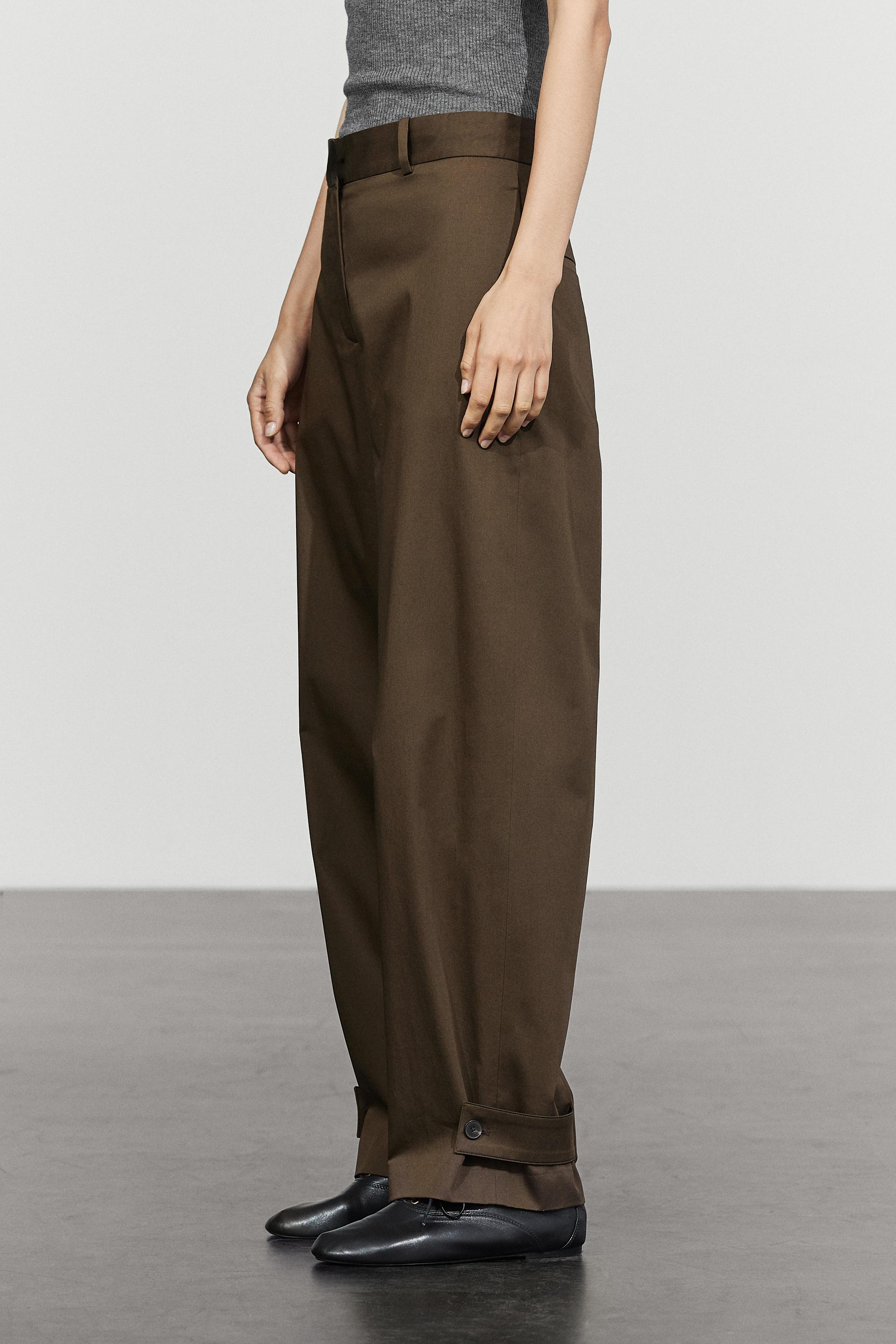 Pants with buttoned hem detail