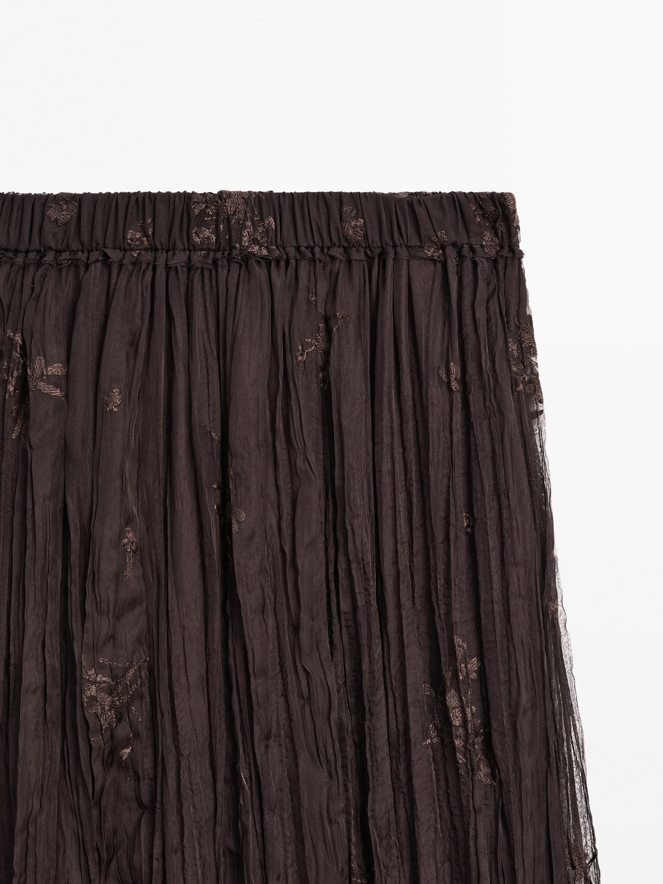 Long pleated skirt with embroidered detail